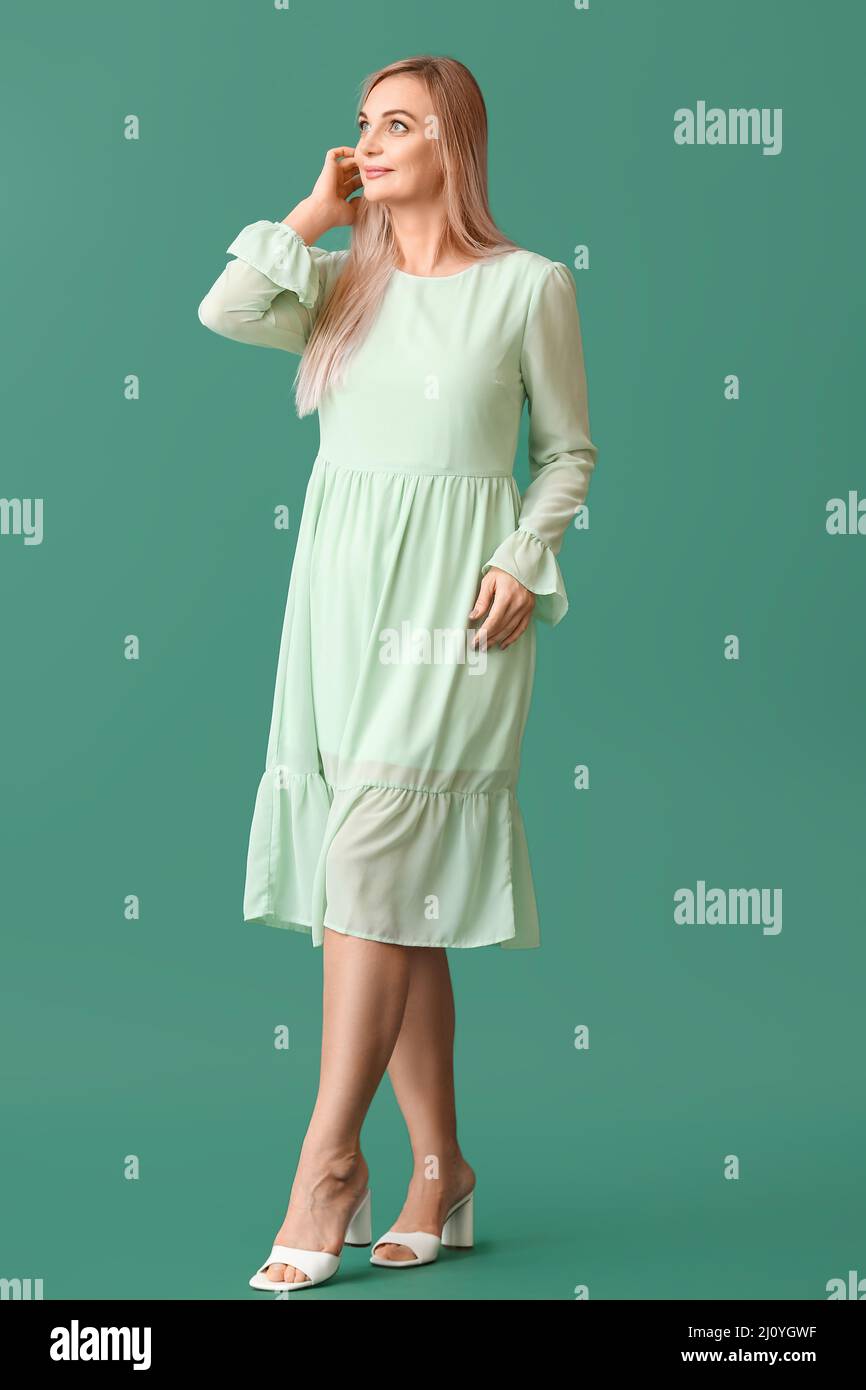 Beautiful blonde woman on green background Stock Photo - Alamy