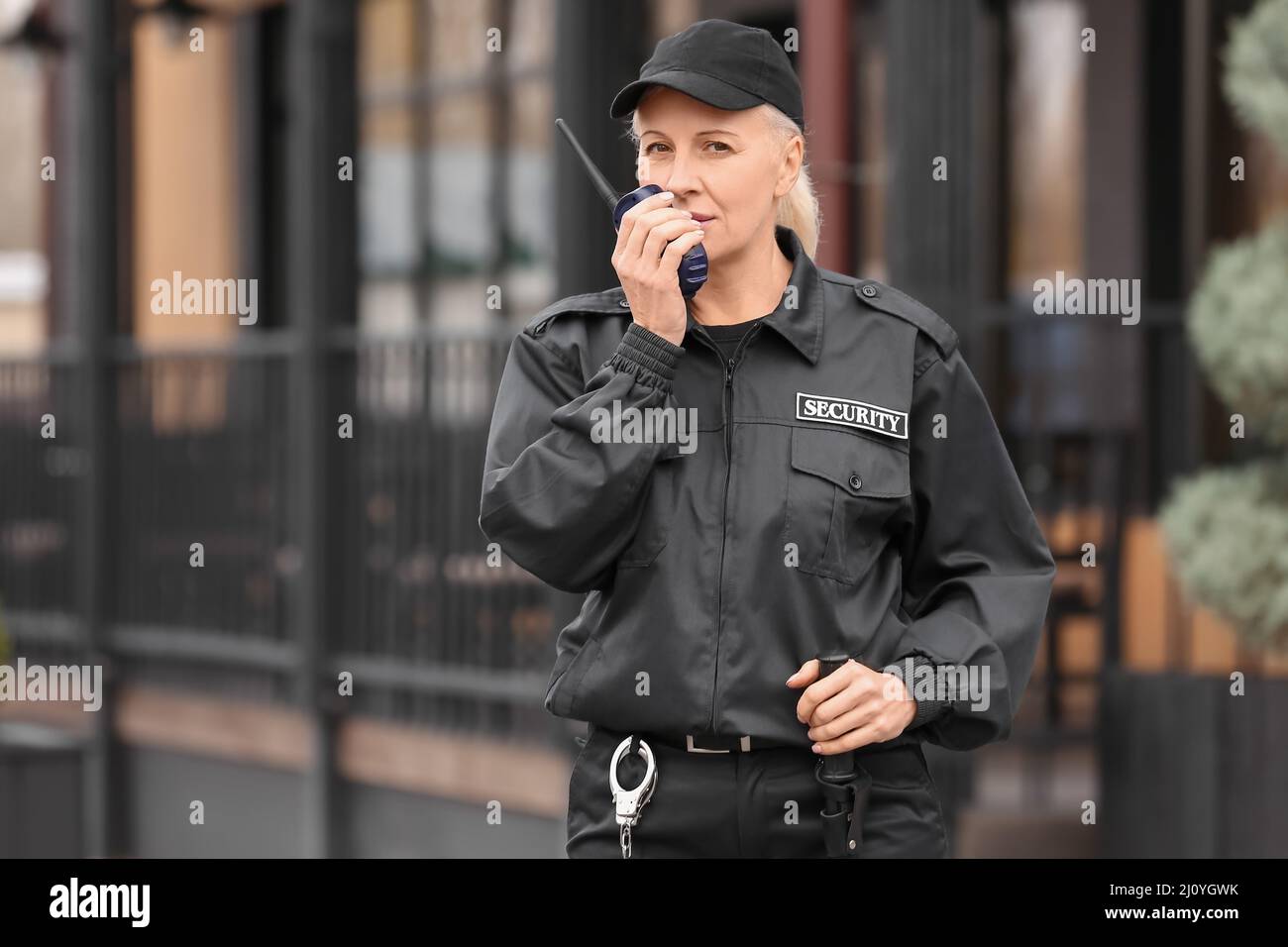 Female security guard with radio transmitter outdoors Stock Photo Alamy