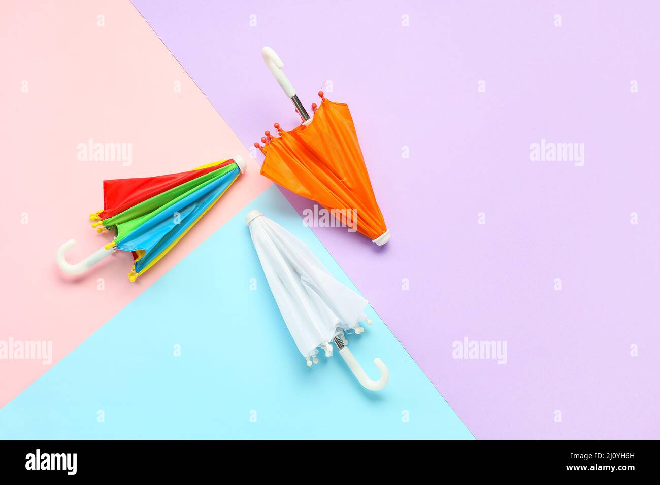 Three umbrellas on color background Stock Photo