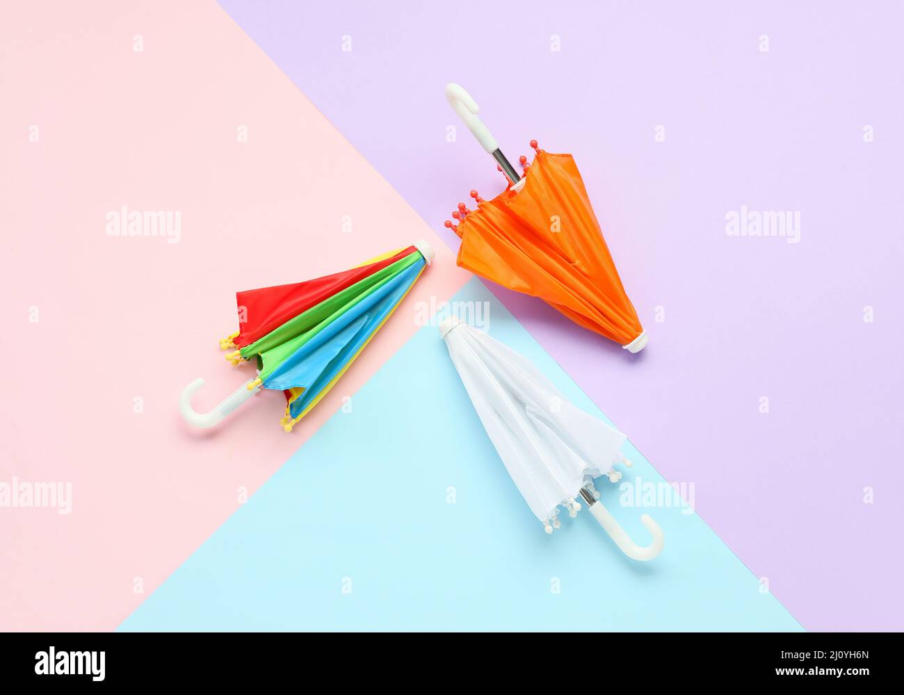 Three umbrellas on color background Stock Photo