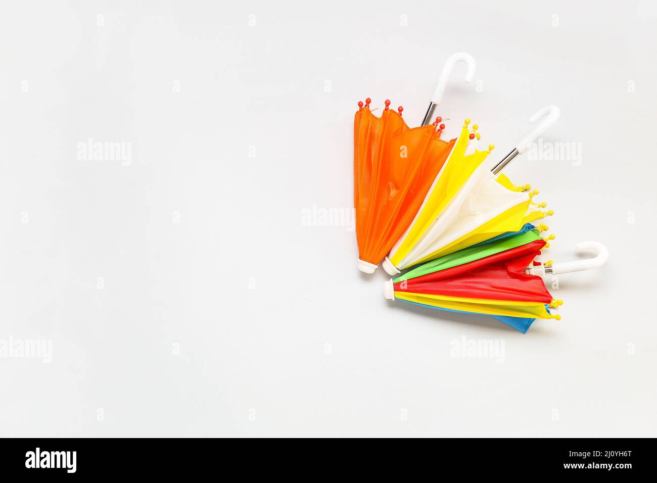 Different umbrellas on white background Stock Photo