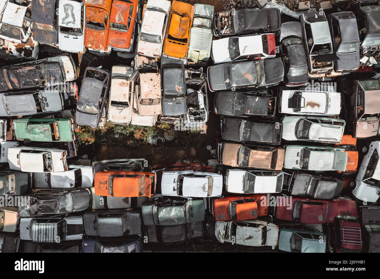 Aerial view of a Soviet automobile dump from a drone. Shooting from above at heaps of rusty cars. Abandoned Russian cars awaiting disposal and Stock Photo