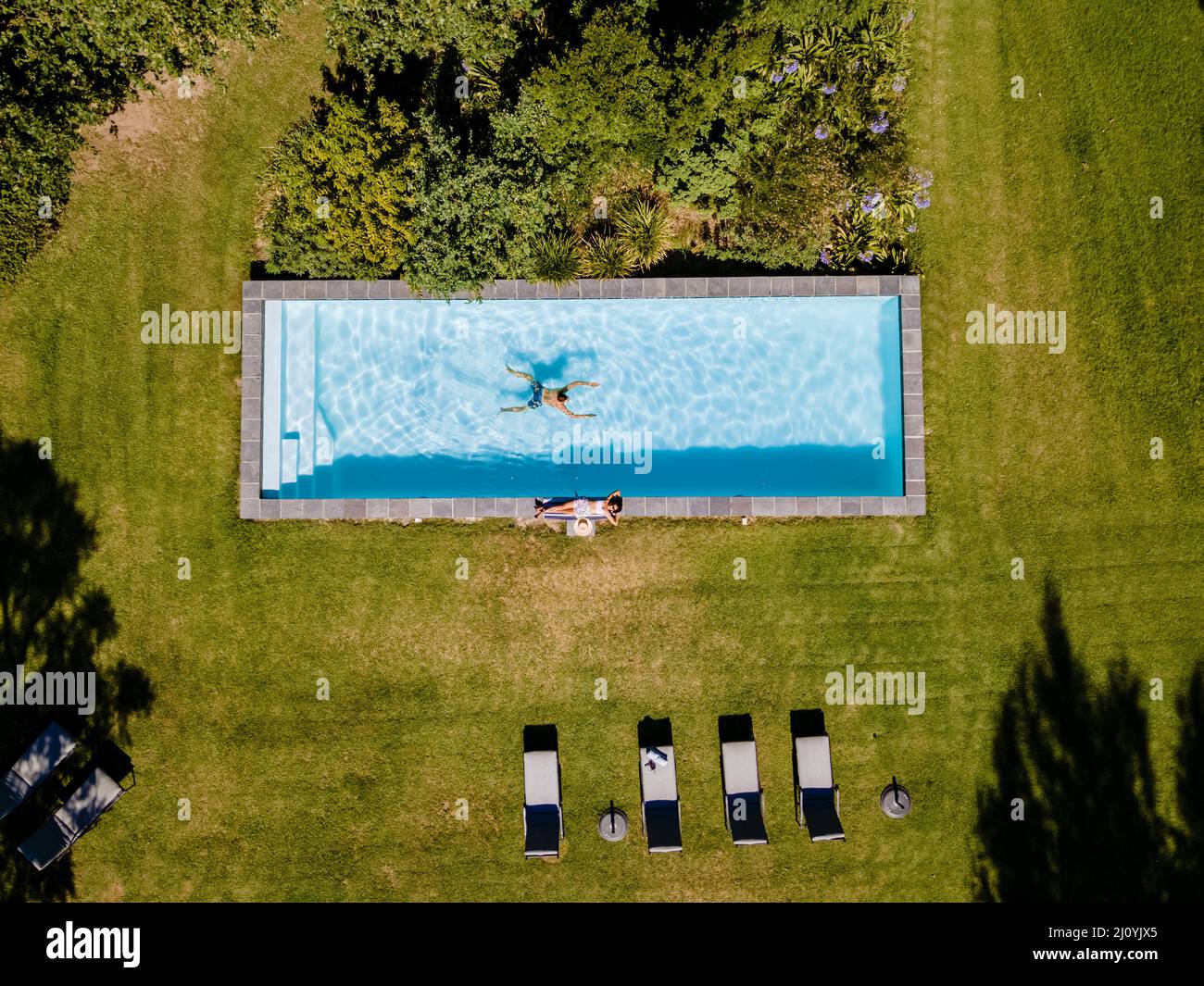Drone view at swimming pool above with man and woman swimming Stellenbosch, near Cape Town, South Africa Stock Photo