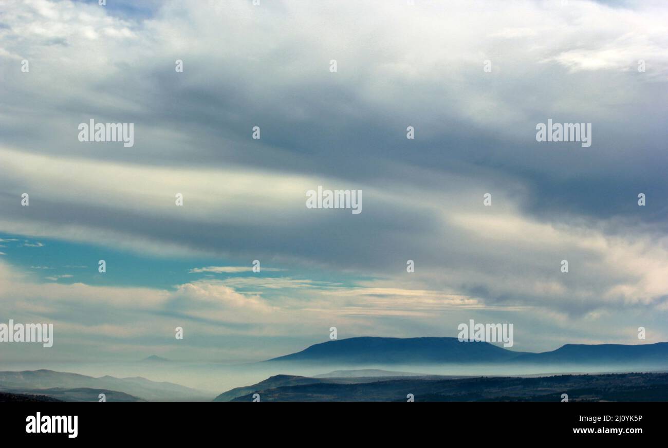 foggy mountain and clouds in the sky Stock Photo - Alamy