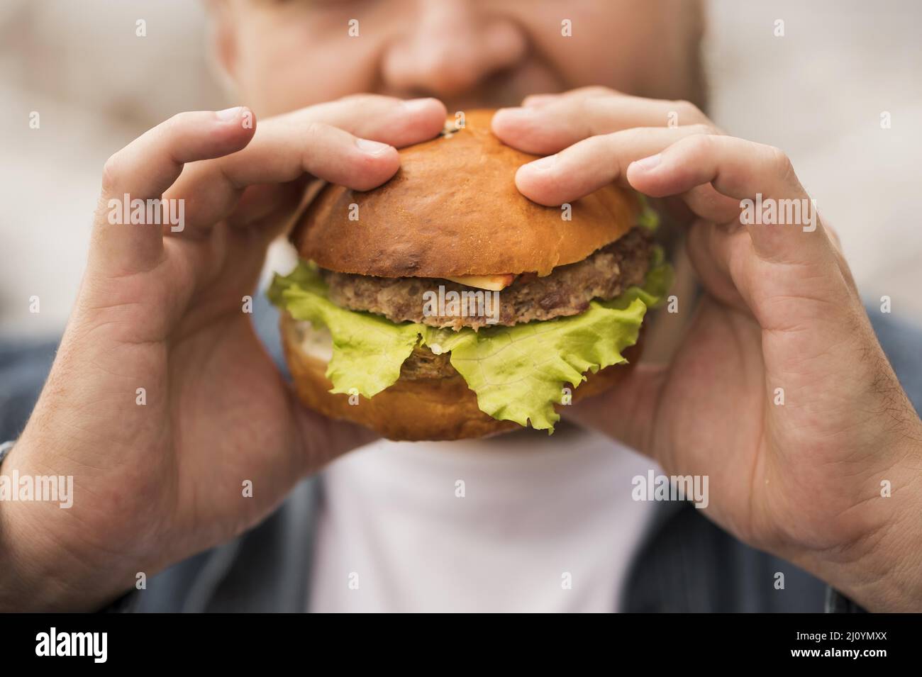 Close up man eating burger. High quality photo Stock Photo - Alamy