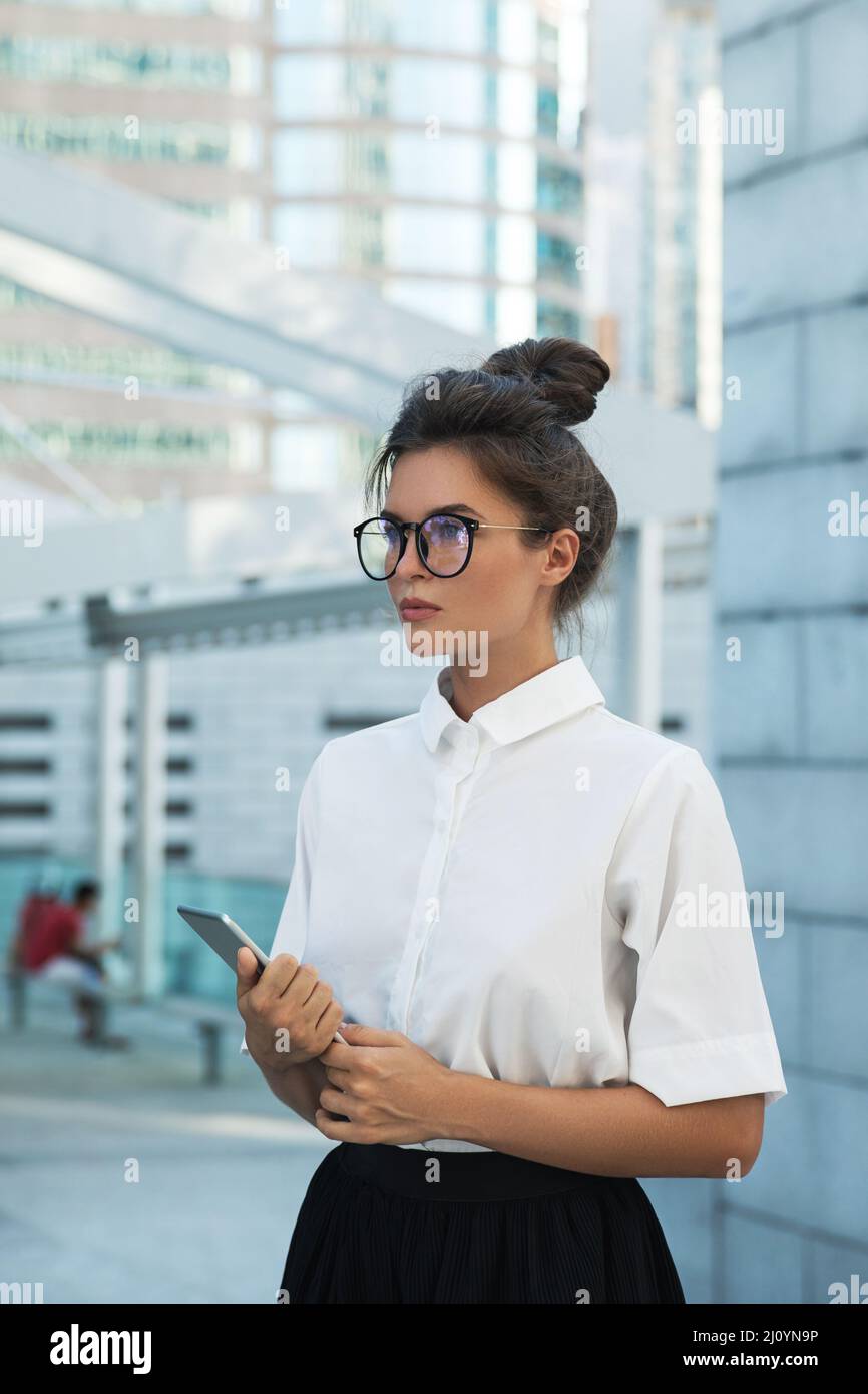 Woman wearing smart casual clothing is using tablet pc Stock Photo