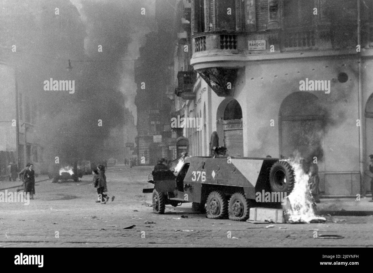 A Soviet-built BTR-152 armored personnel carrier burns on a Budapest street, November 1956  during the 1956 Hungarian Revolution. Stock Photo