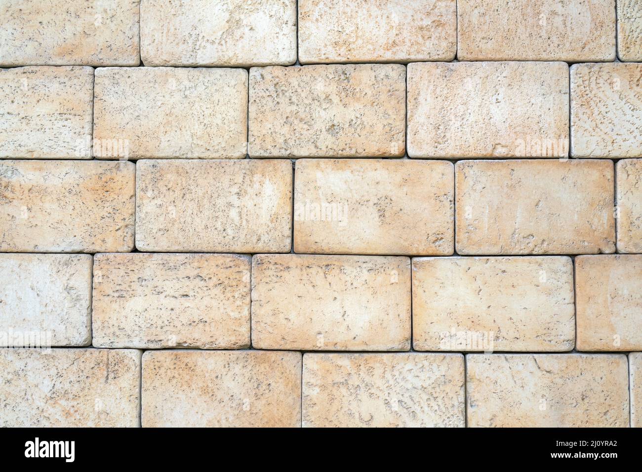Texture of yellow brick made of sandstone and limestone. The wall of the house. Stock Photo