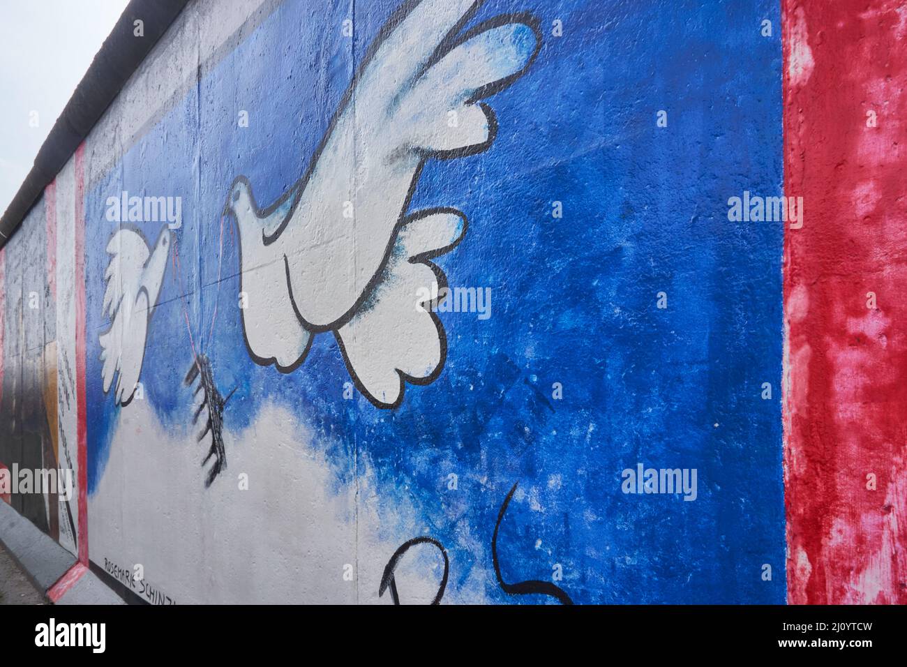 Wall paint of white pigeon at the Eastside gallery in Berlin Stock Photo