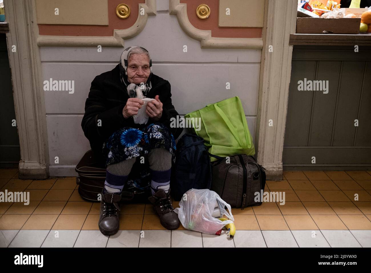 Medyka, Poland. 21st Mar, 2022. Ukrainian refugees at Medyka border crossing in Przemysl County, Poland, on March 17, 2022. Old lady sitting at the train station Przemysl, alone, obersing around her, not knowing where to go next. Credit: Abaca Press/Alamy Live News Stock Photo