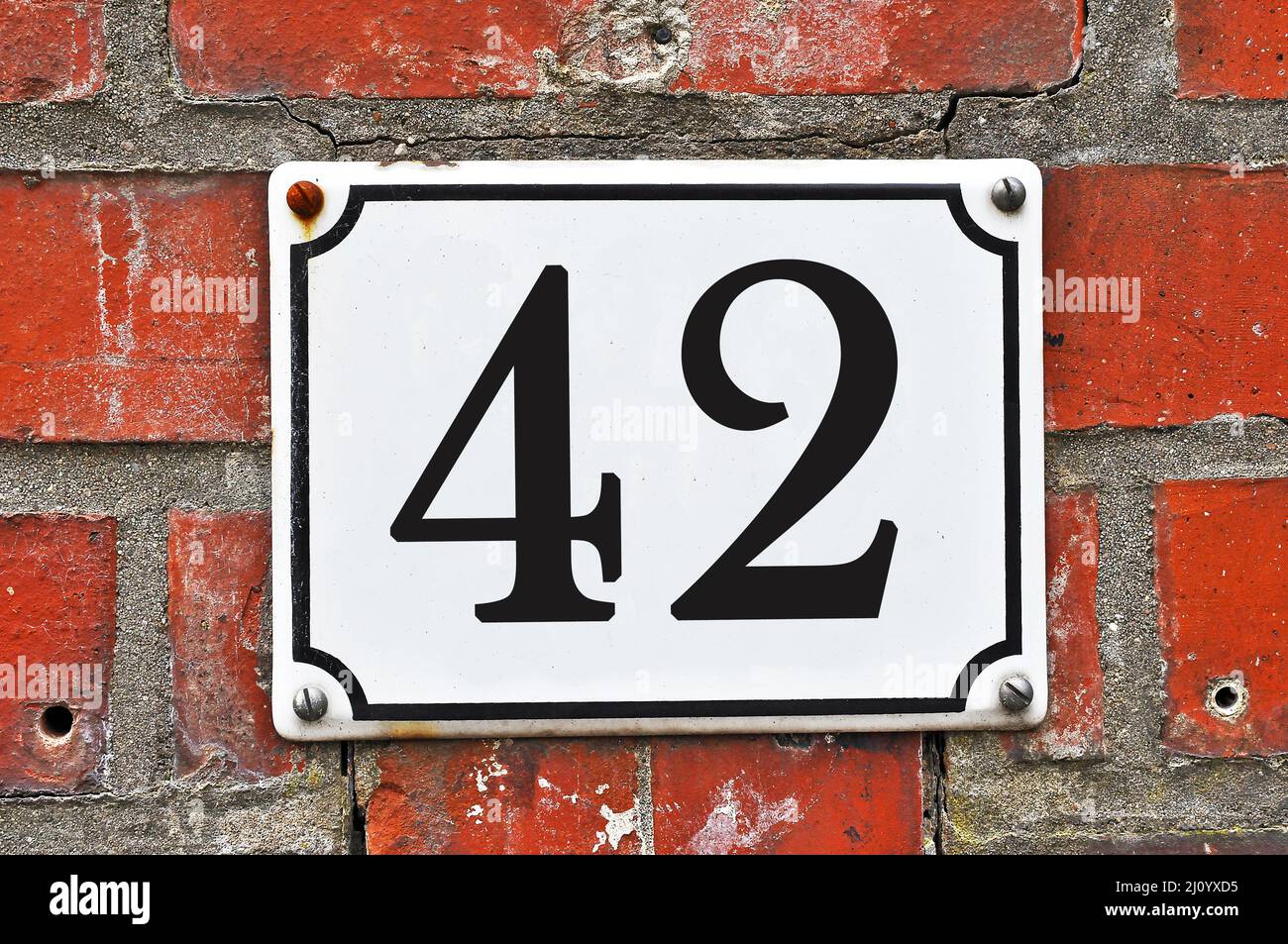 Sign of a street number 42 on a red brick wall Stock Photo - Alamy