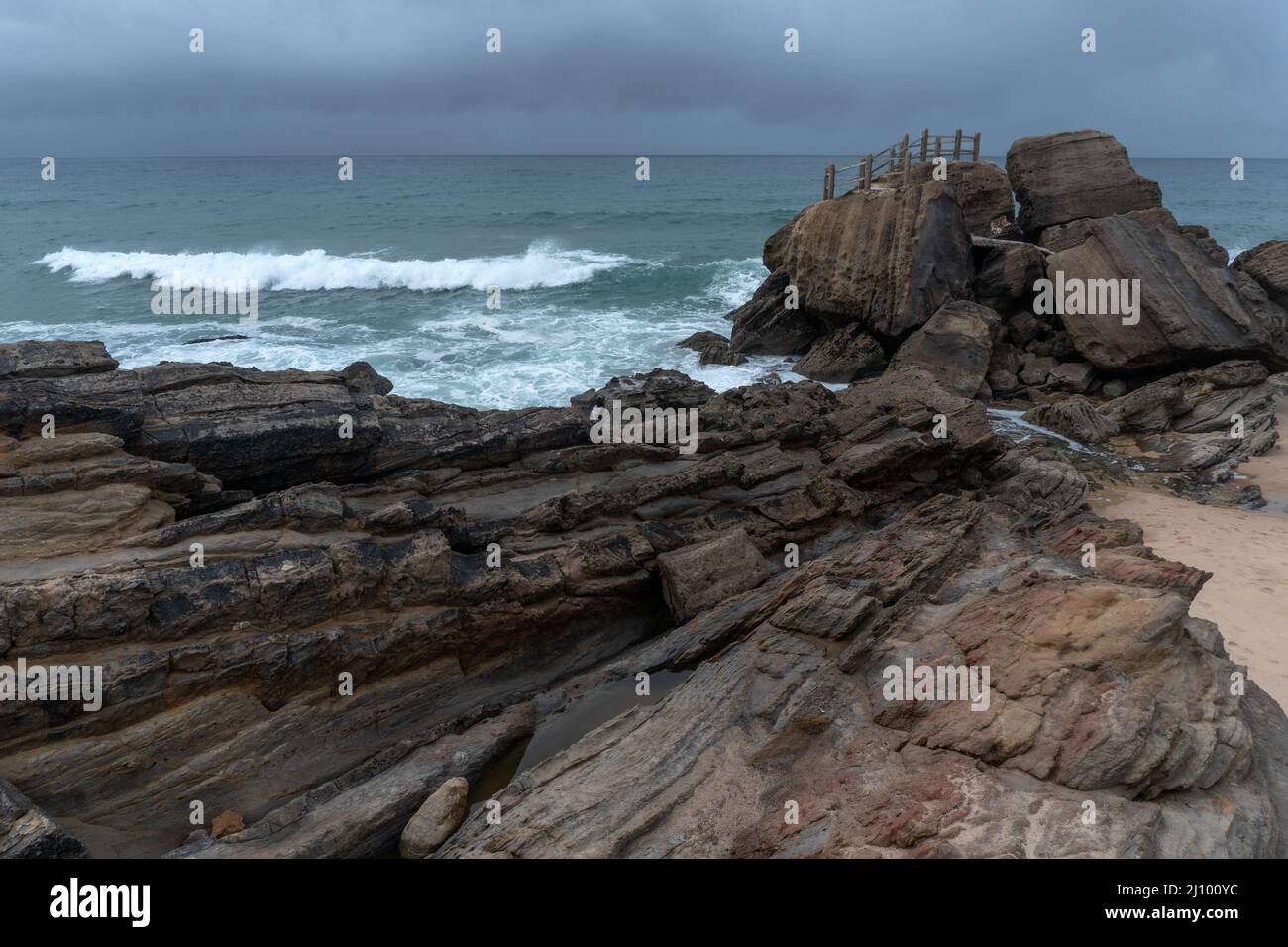Santa Cruz beach with its famous natural rock formation in winter, Portugal. Stock Photo