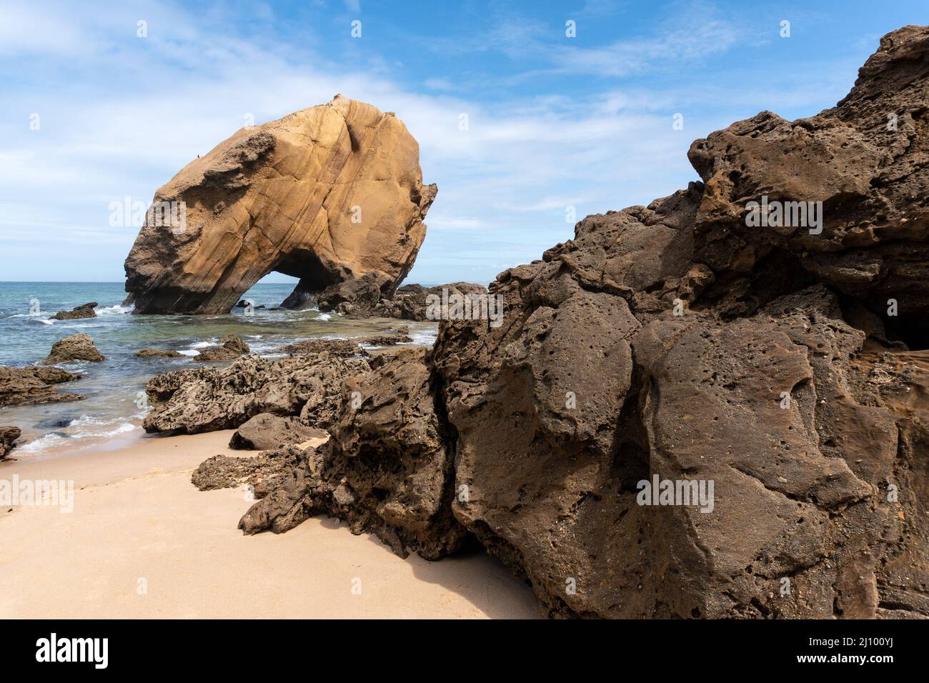 Santa Cruz beach with its famous natural arch formation at sunset, Portugal. Stock Photo