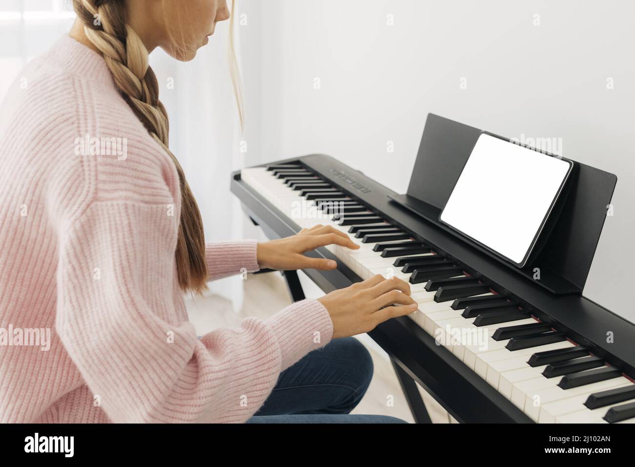 Young girl playing keyboard instrument Stock Photo Alamy