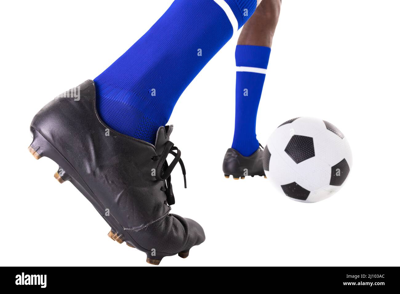 Low section of african american male player kicking soccer ball on ...