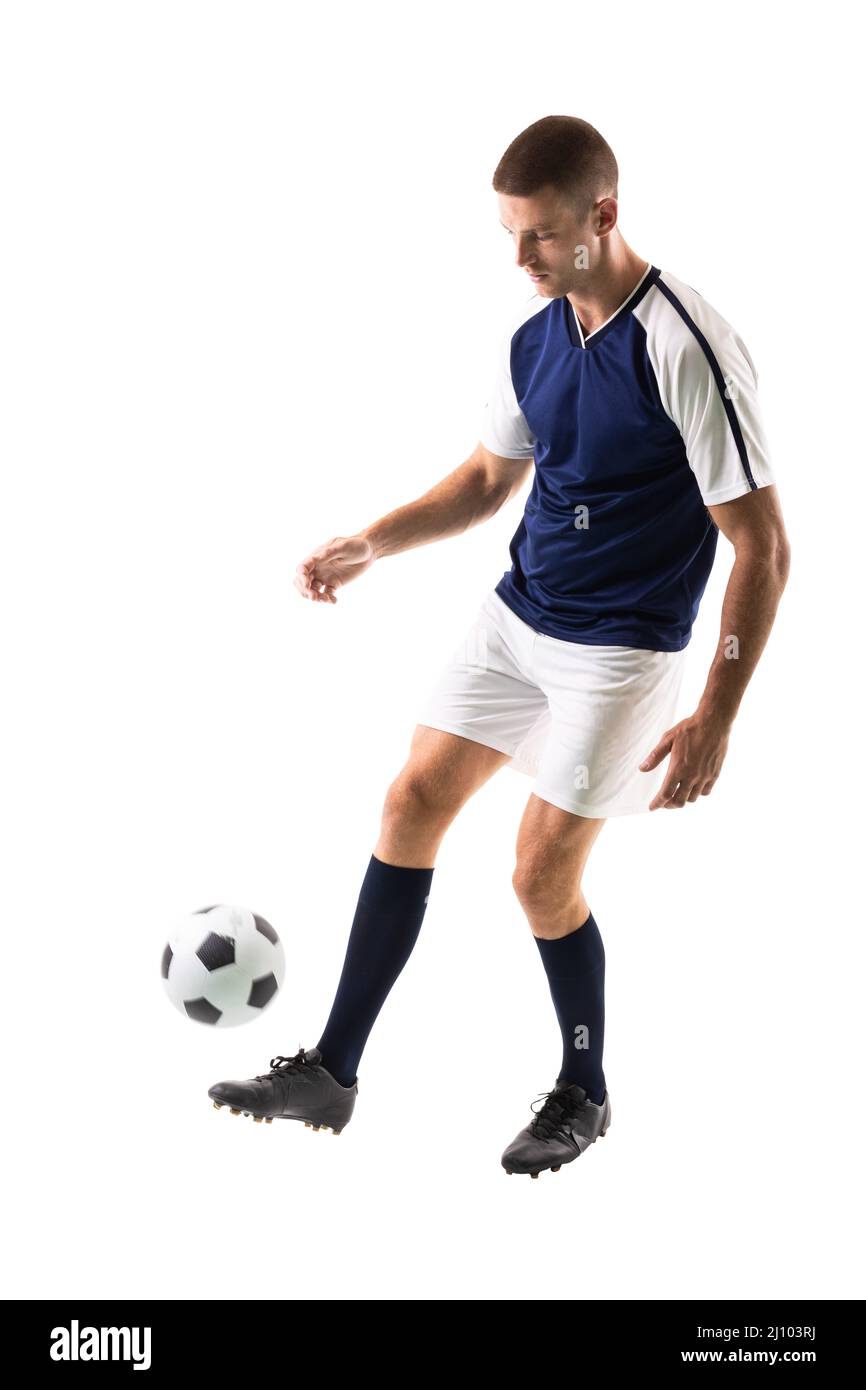 Full length of skilled caucasian male soccer player juggling ball on