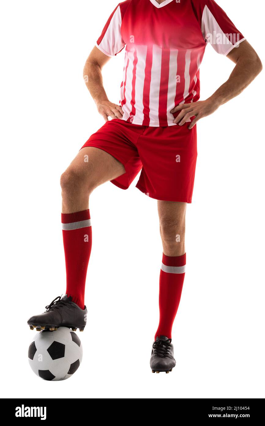 Low section of male caucasian athlete with arms akimbo stepping on ball over white background Stock Photo