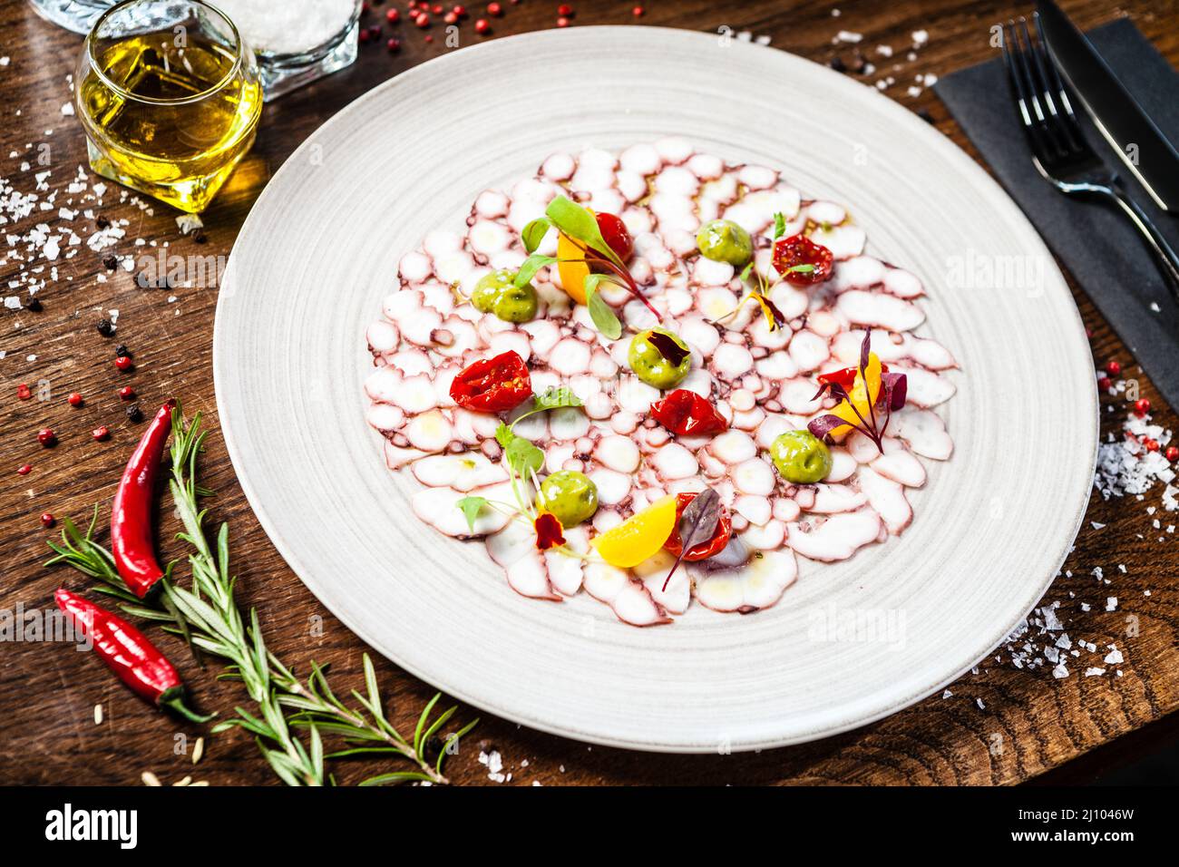 Octopus carpaccio. Spinach cream, cherry tomatoes. Delicious healthy ...