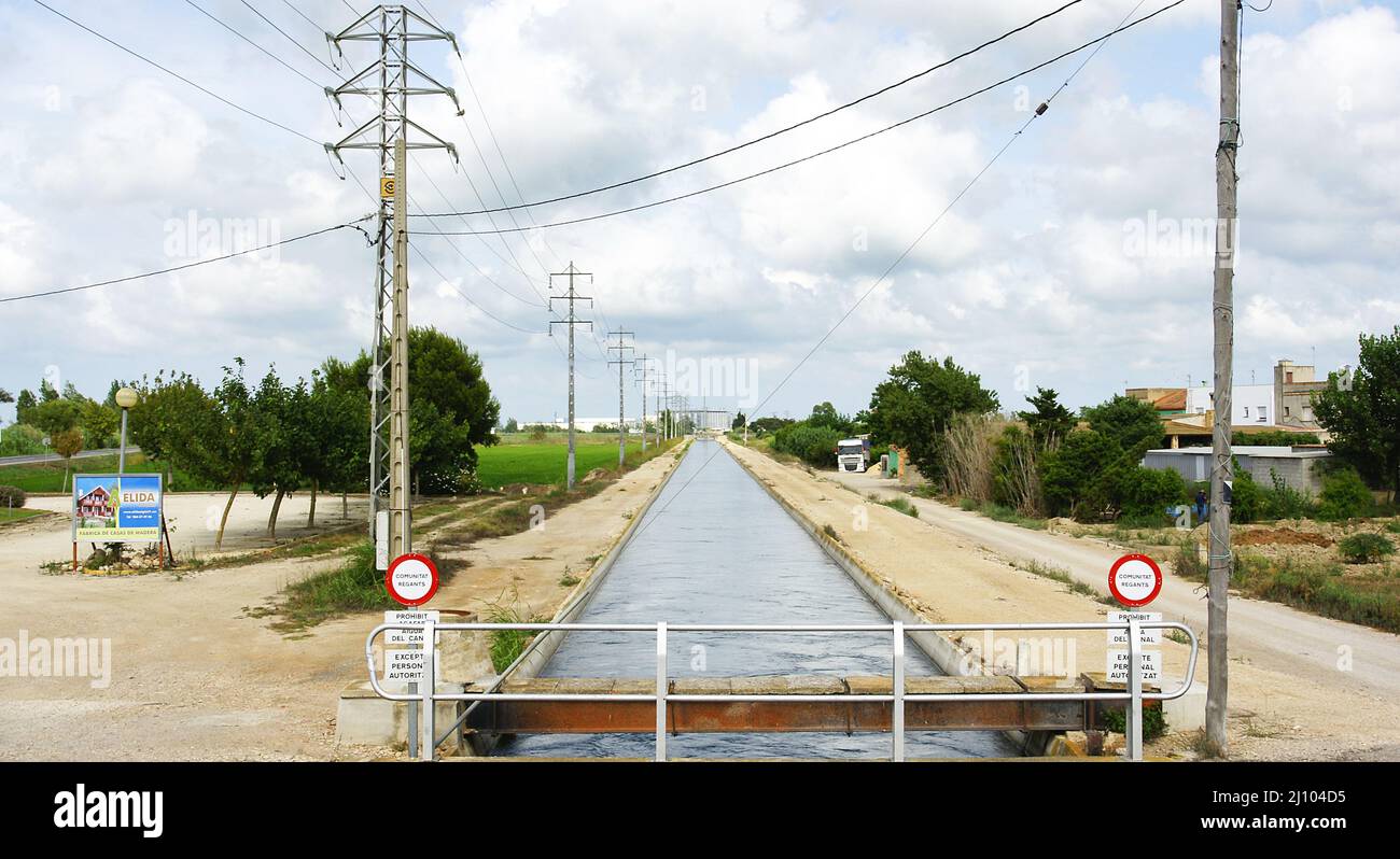 Irrigation channel in the rice plantations of the Ebro Delta in Amposta, Tarragona, Catalunya, Spain, Europe Stock Photo