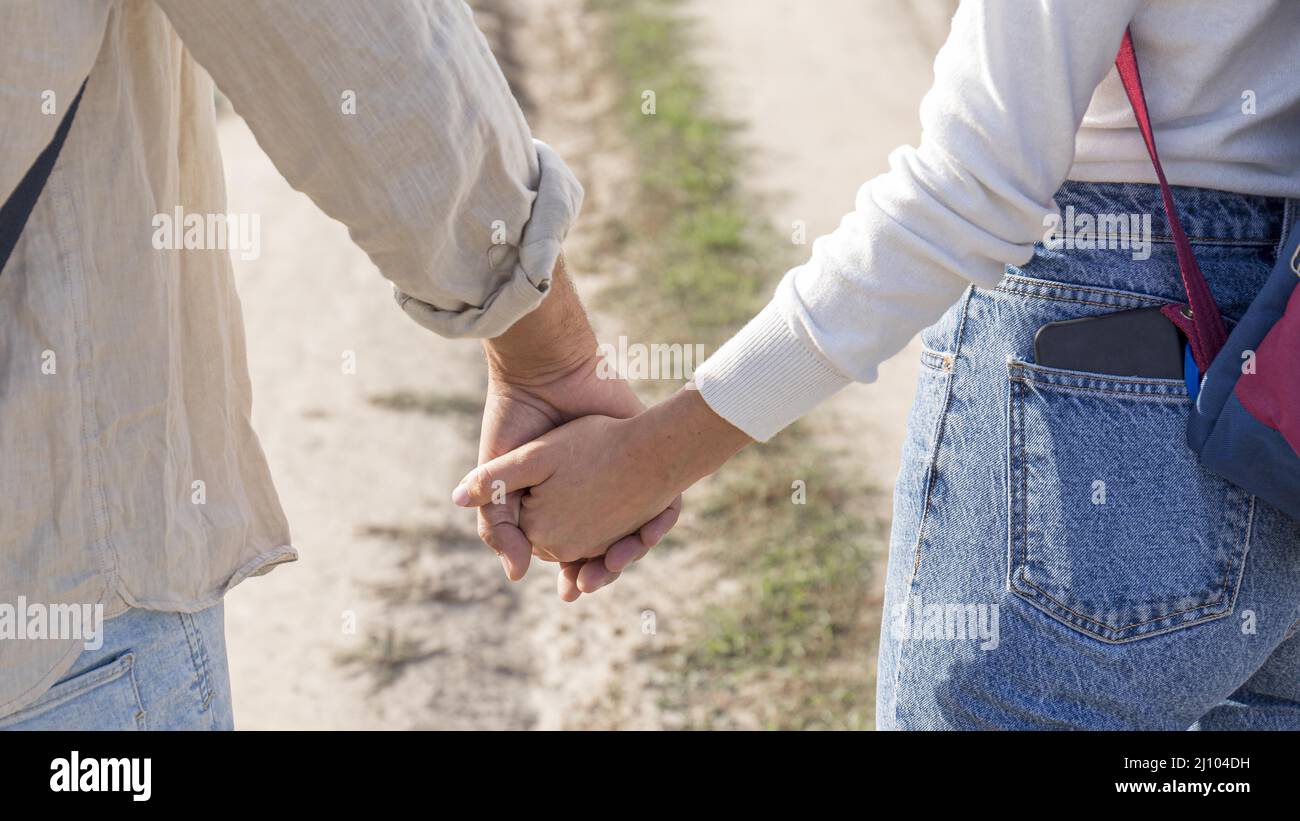 Young couple holding hands close hi-res stock photography and images ...