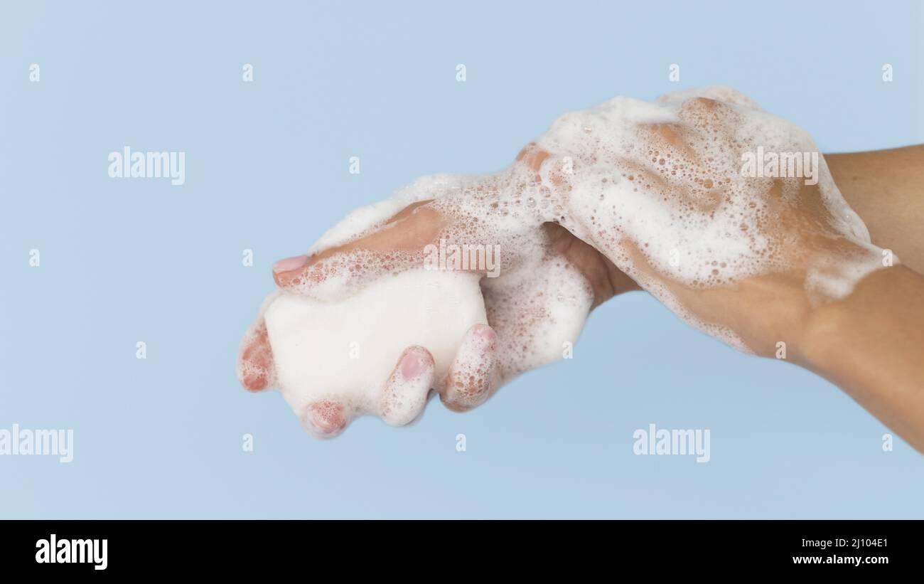 Person washing hands with soap Stock Photo
