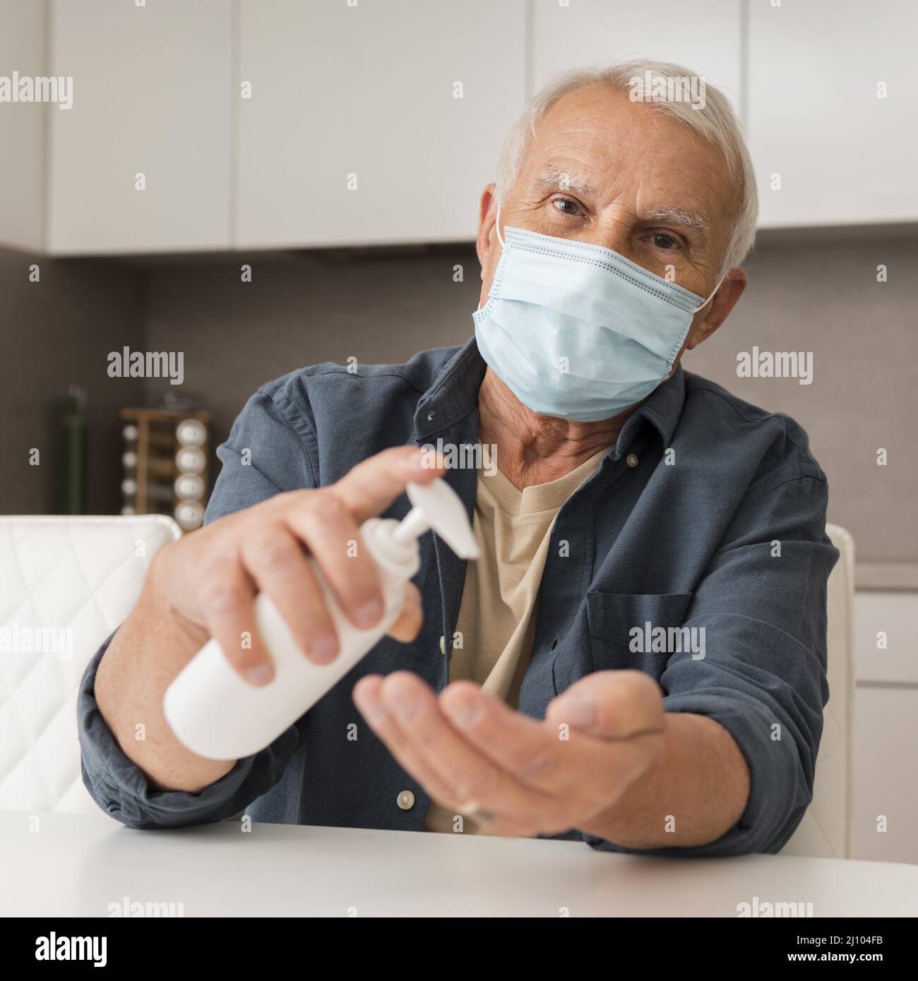Front view man with mask disinfectant Stock Photo