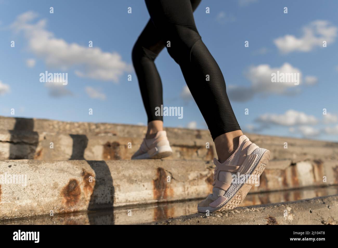 Woman jogging stairs close up Stock Photo