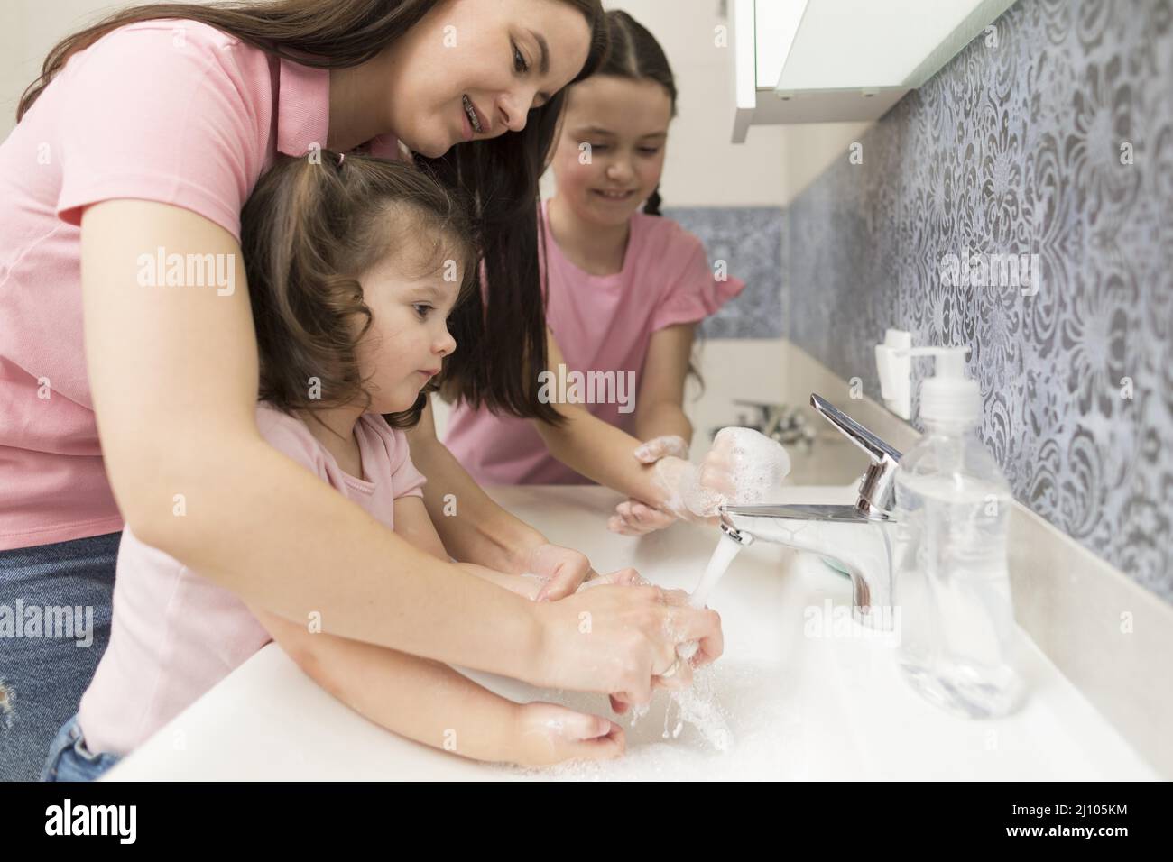 Mother learning girl wash hands Stock Photo