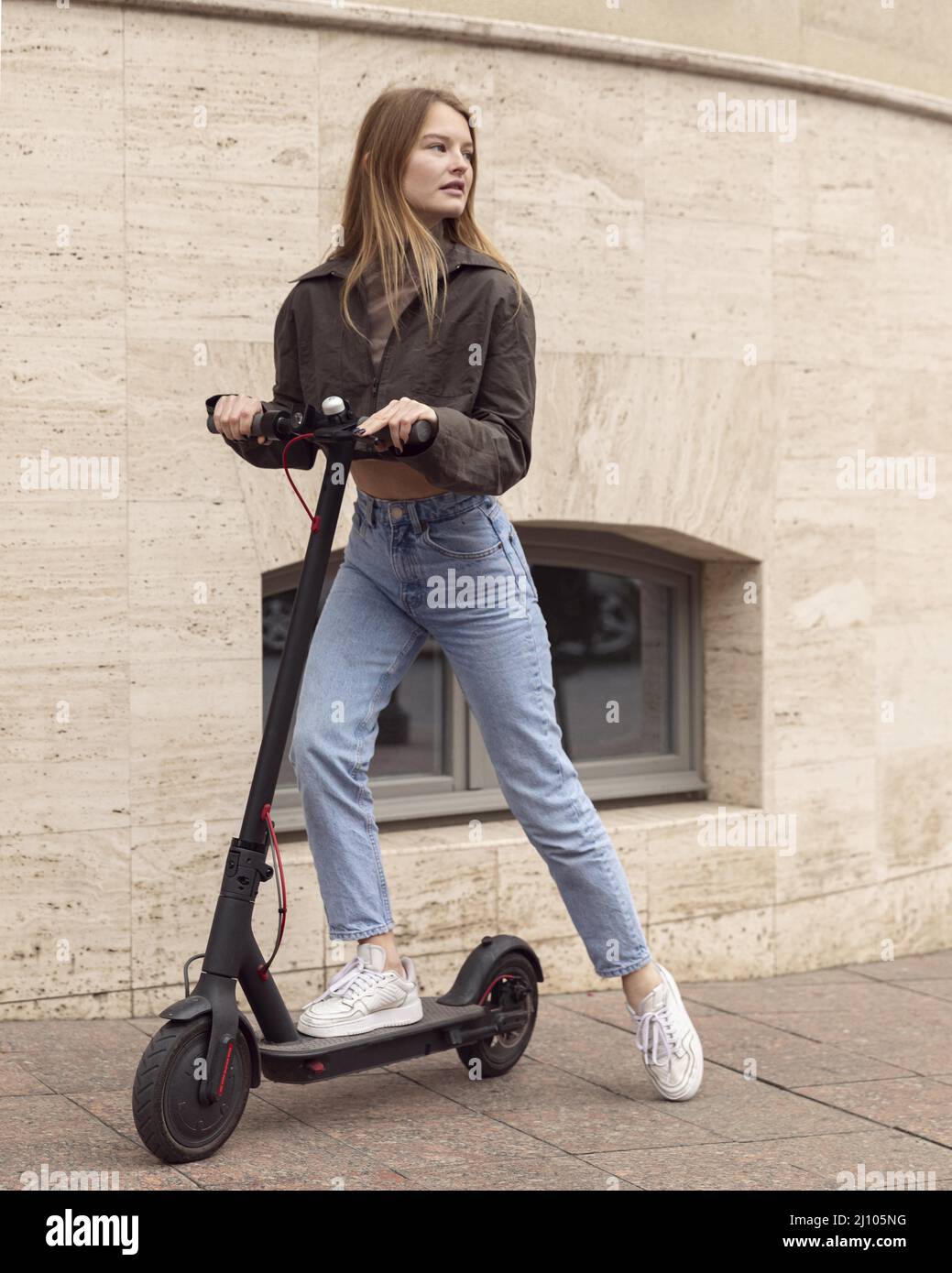 Woman electric scooter outdoors Stock Photo