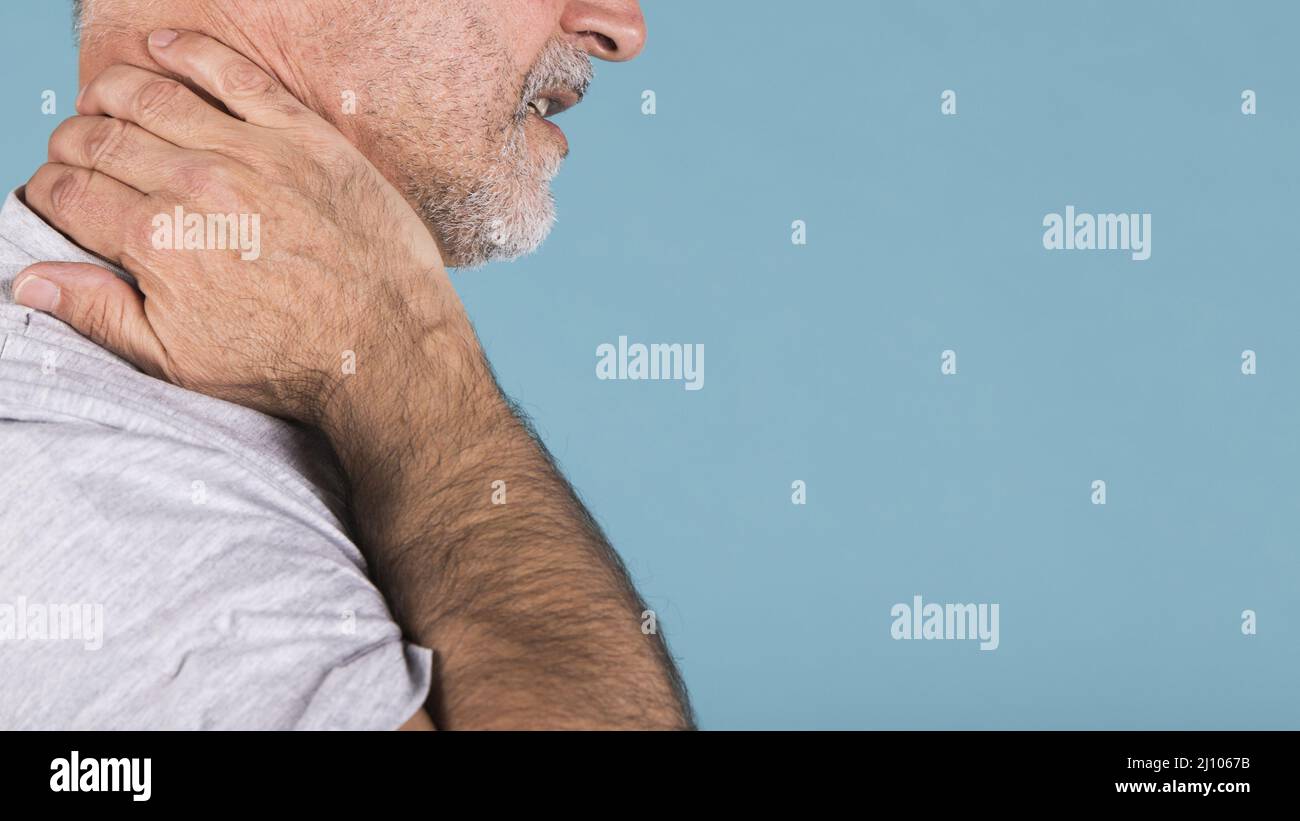 Side view senior man suffering from neck pain Stock Photo