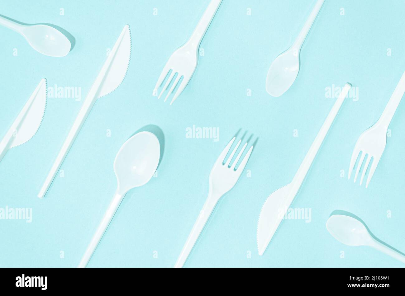 White disposable cutlery composition turquoise background Stock Photo