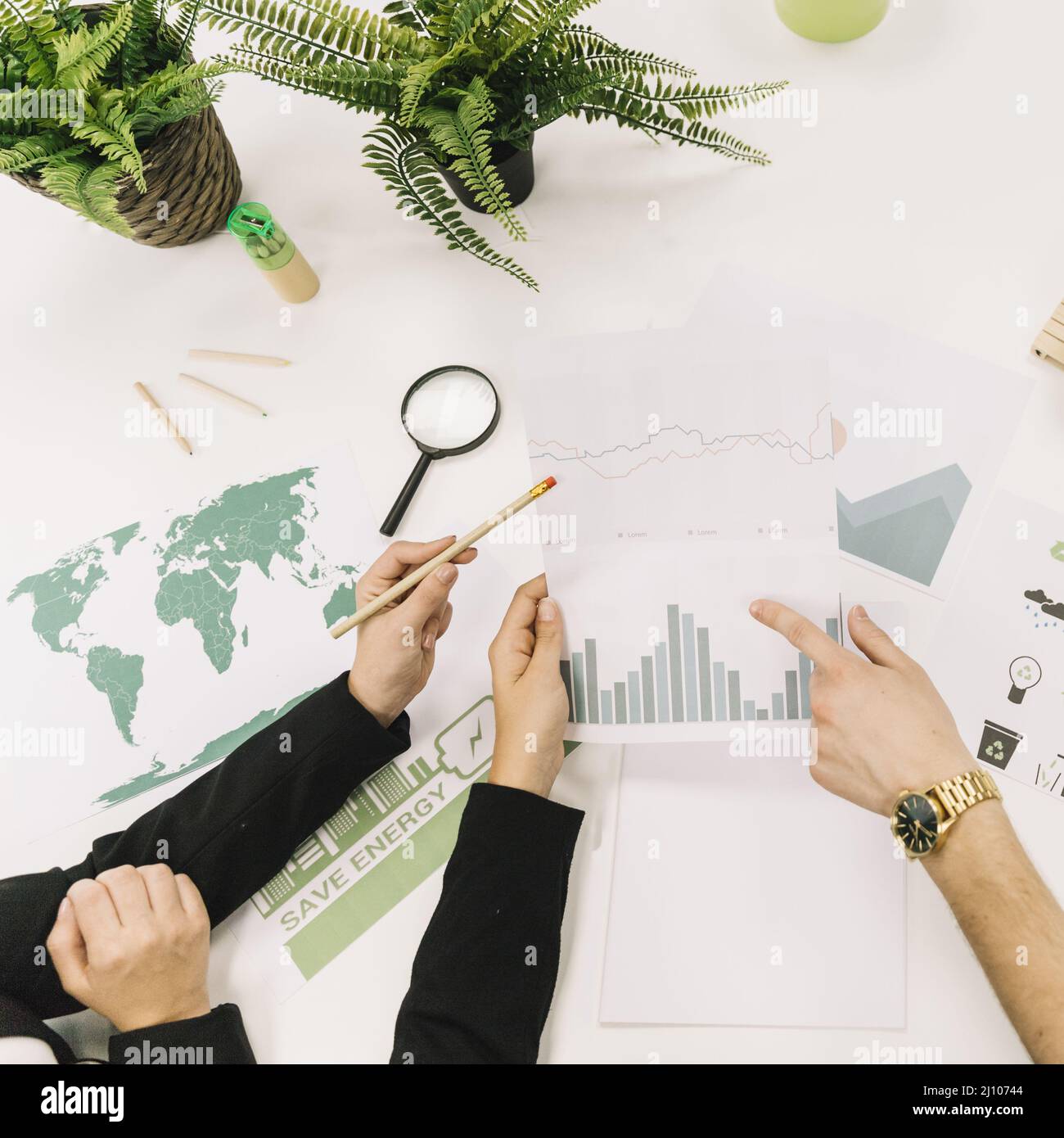 Elevated view businesspeople analyzing graph desk Stock Photo
