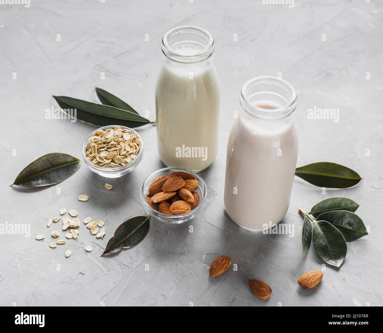 High angle milk bottles with almonds oats Stock Photo