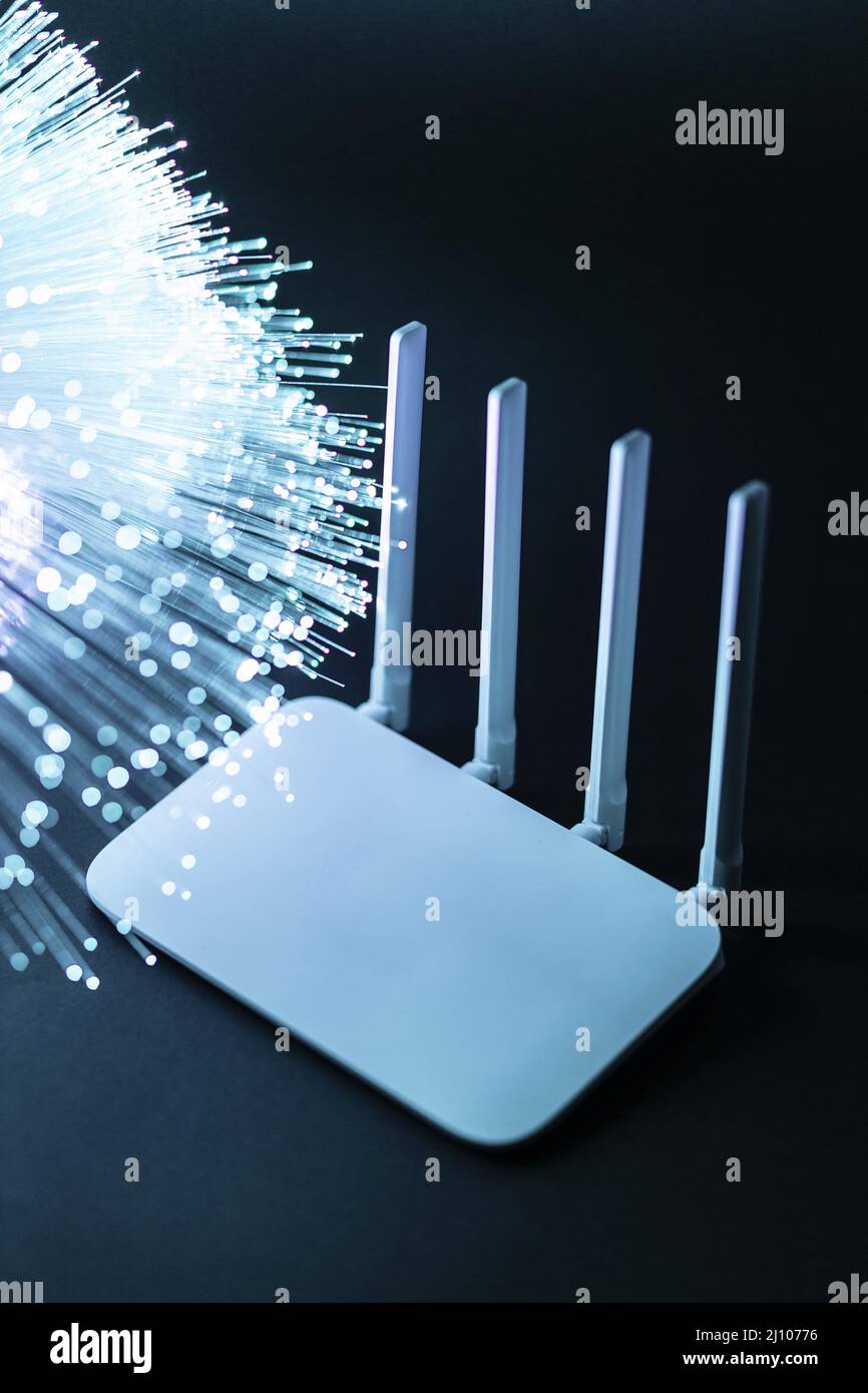Wi fi router with blue optical fiber Stock Photo
