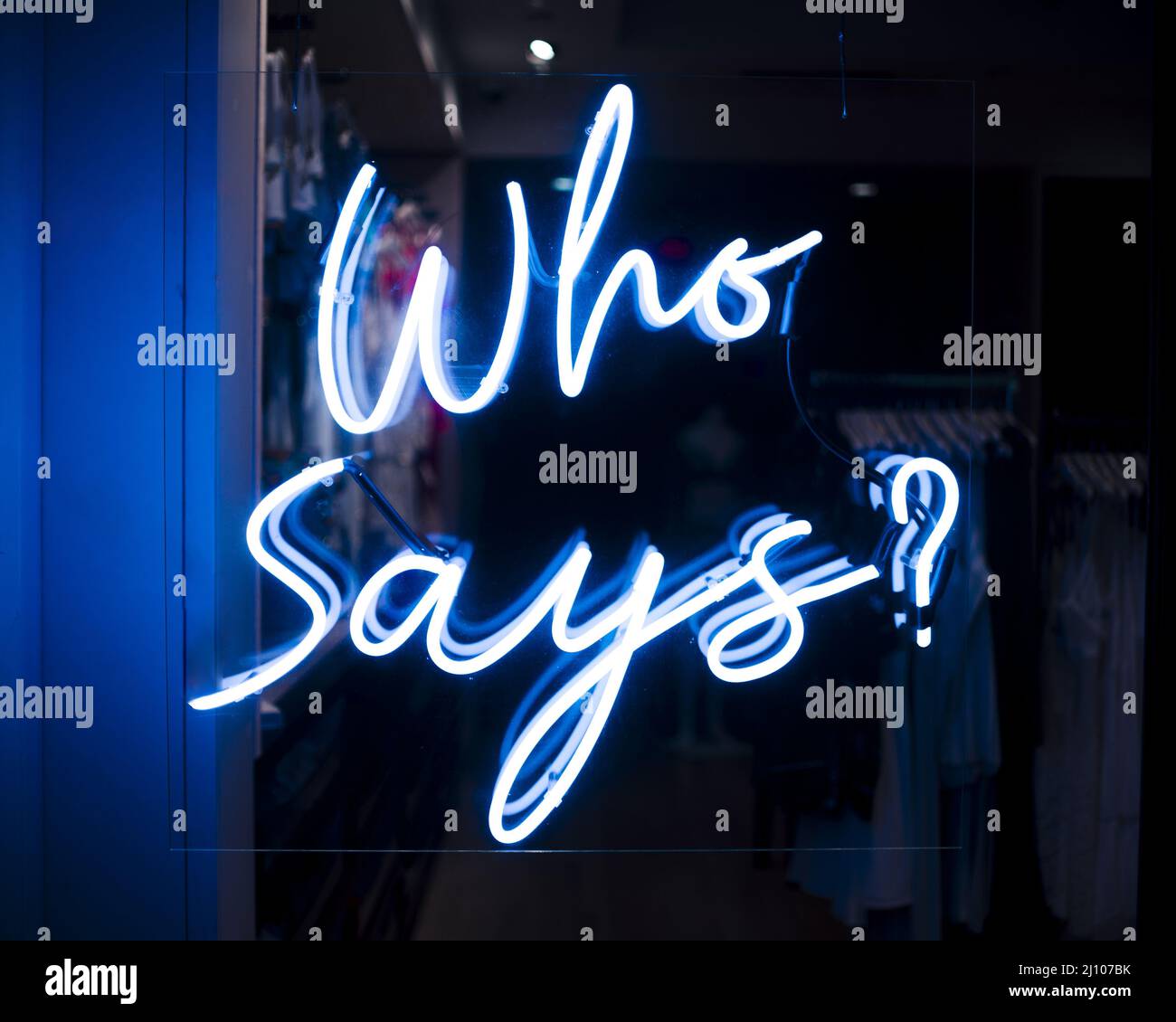 Who says quote sign neon lights Stock Photo