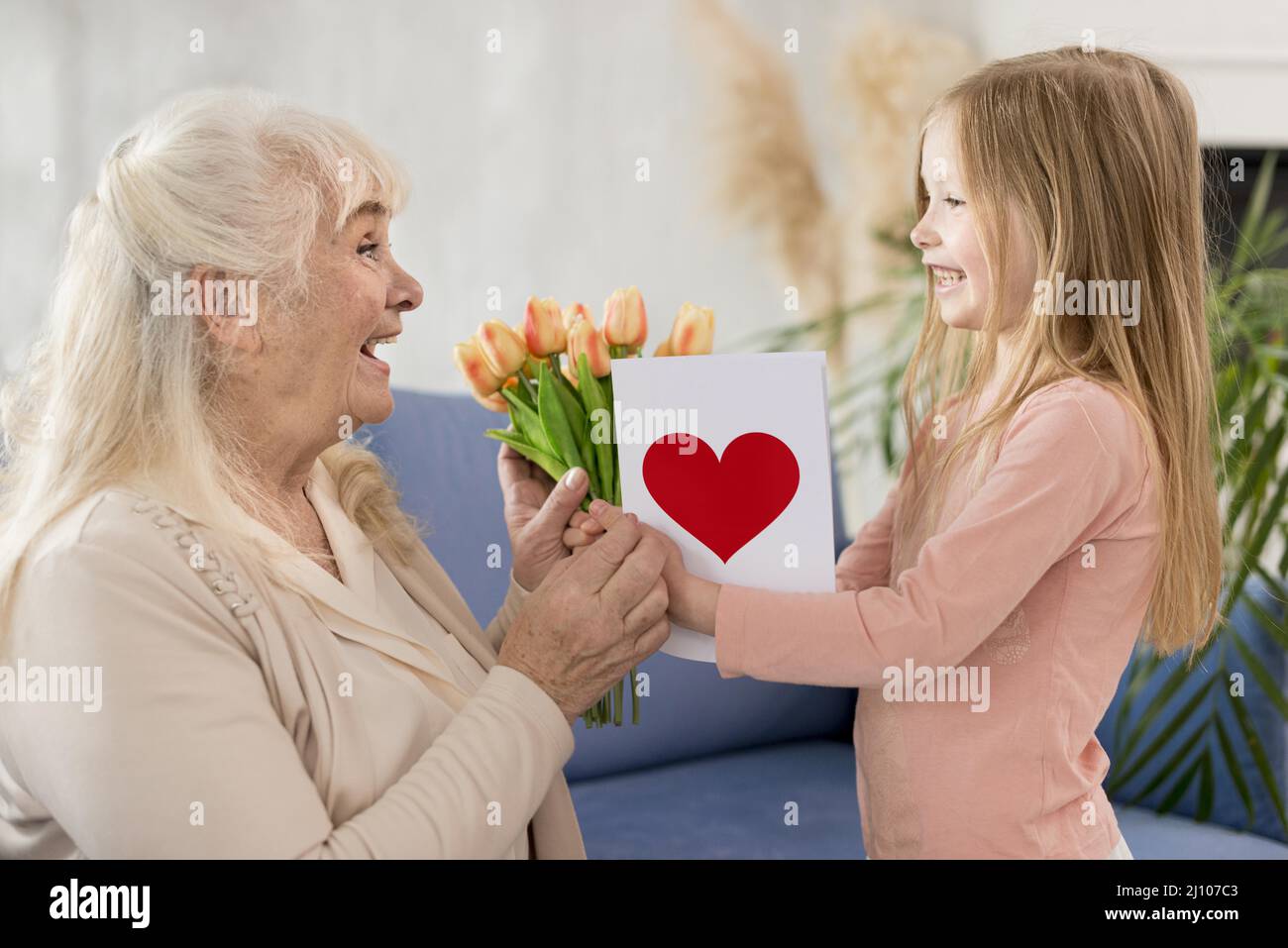 Grandma with flowers from little girl Stock Photo