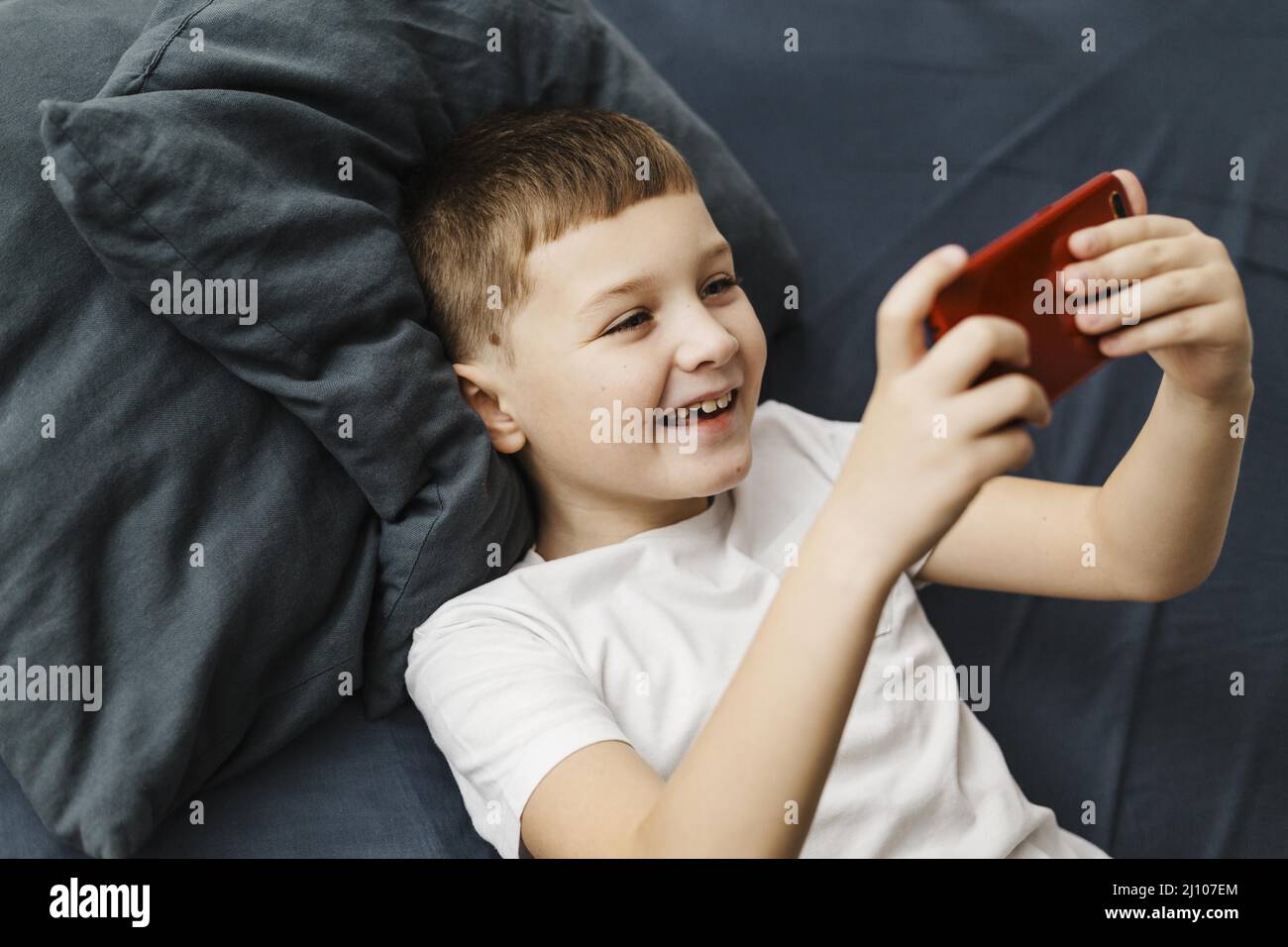 High view child playing mobile phone Stock Photo