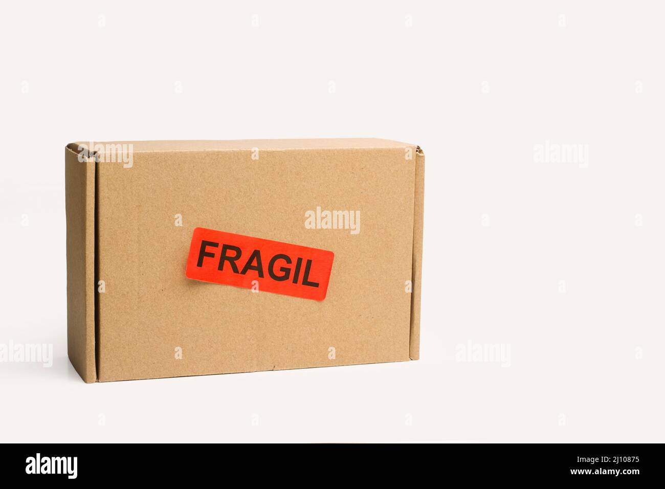 A cardboard box with a fragile stamp on a white background with copy space Stock Photo