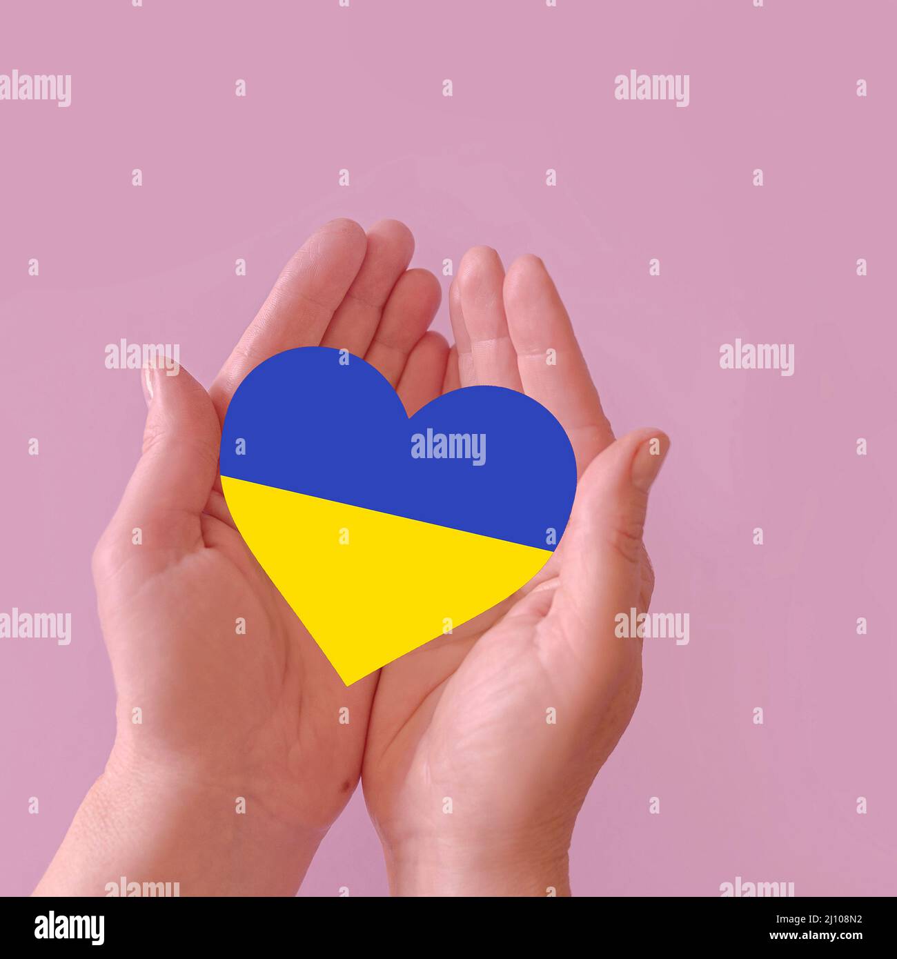 love blue and yellow heart in hands on colorful background.  Ukraine concept Stock Photo