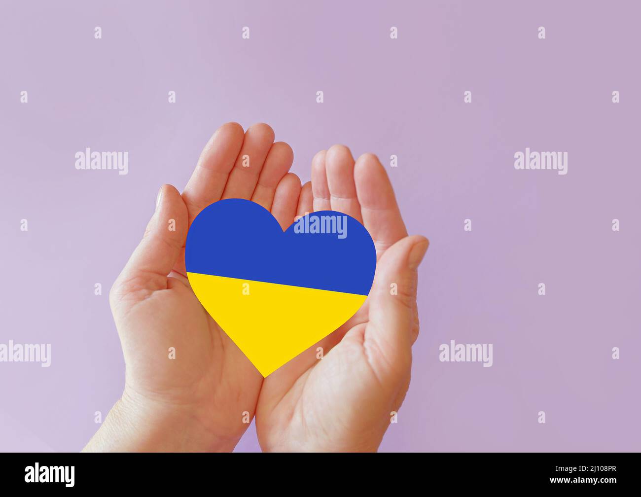 love blue and yellow heart in hands on colorful background.  Ukraine concept Stock Photo