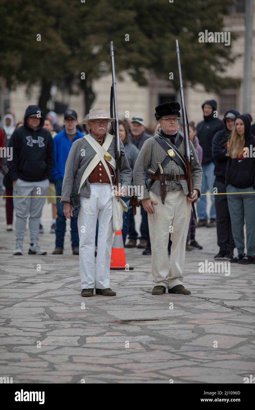 Visitors await a demonstration of firing muskets at the Alamo in San Antonio, Texas Stock Photo