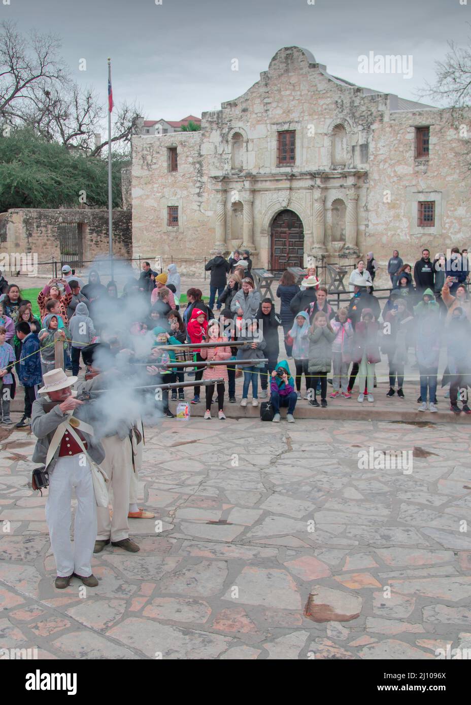 Visitors watch a demonstration of firing muskets at the Alamo in San Antonio, Texas Stock Photo