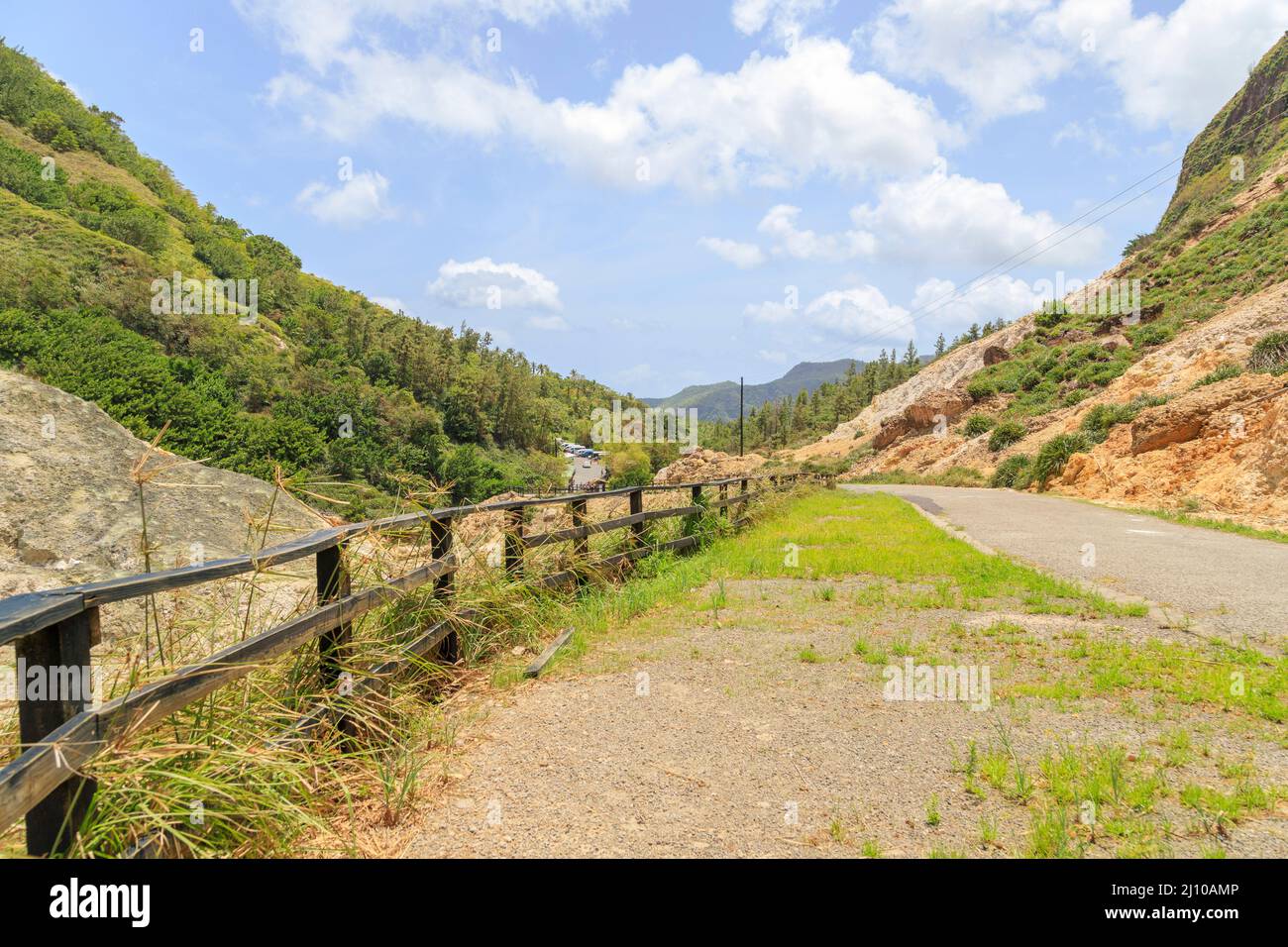 View of the road and wooden railing at the Sulphur Springs in Soufriere Saint Lucia Stock Photo