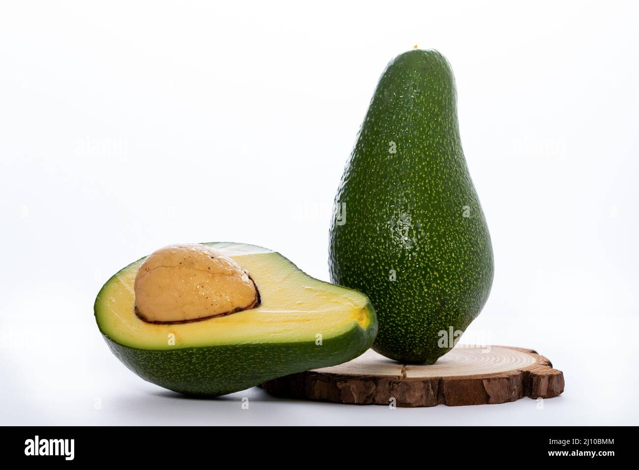 organic avocado on a wooden board white background Stock Photo - Alamy