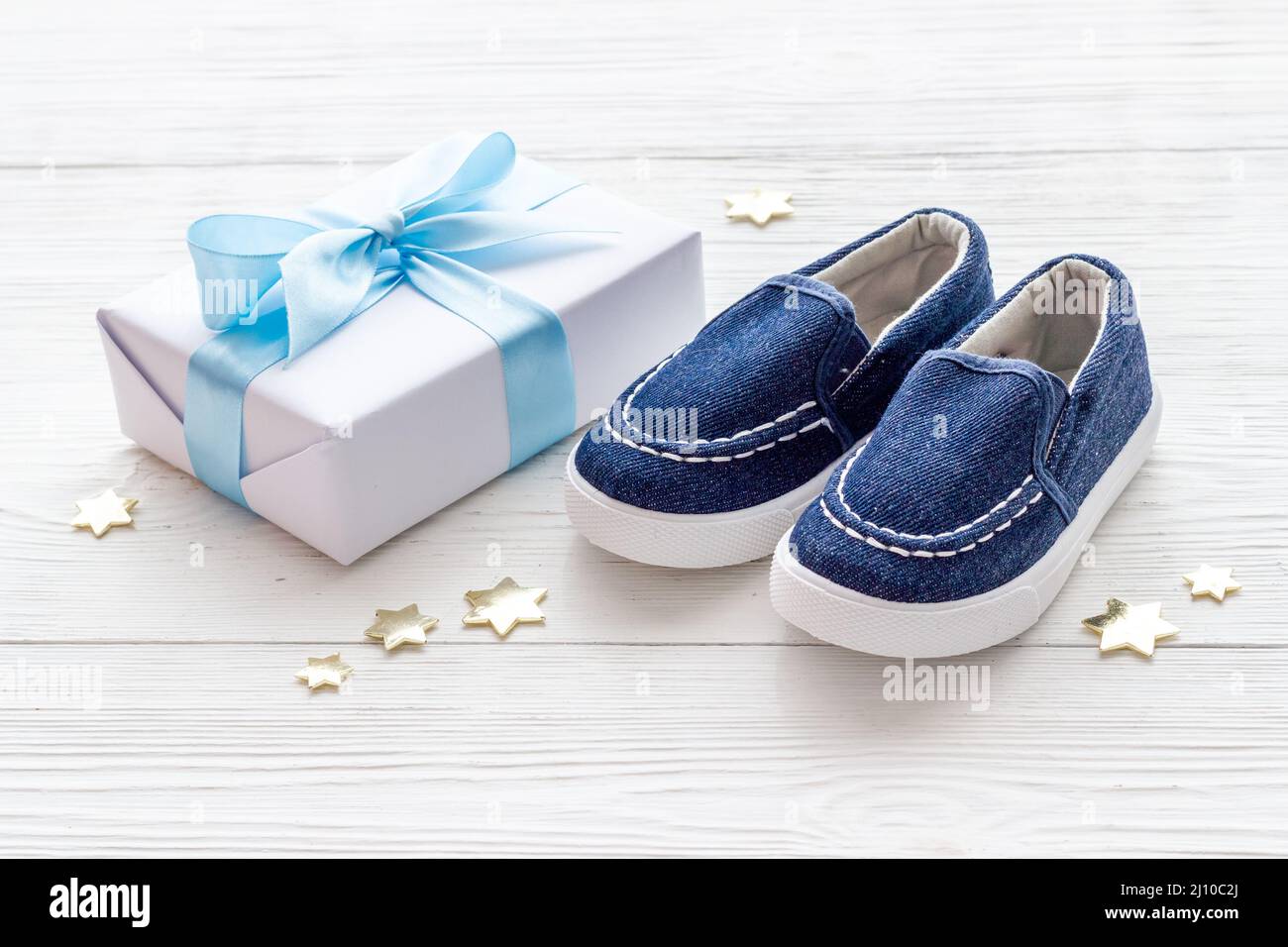 Baby boy blue shoes with gift box. Baby shower party set Stock Photo ...