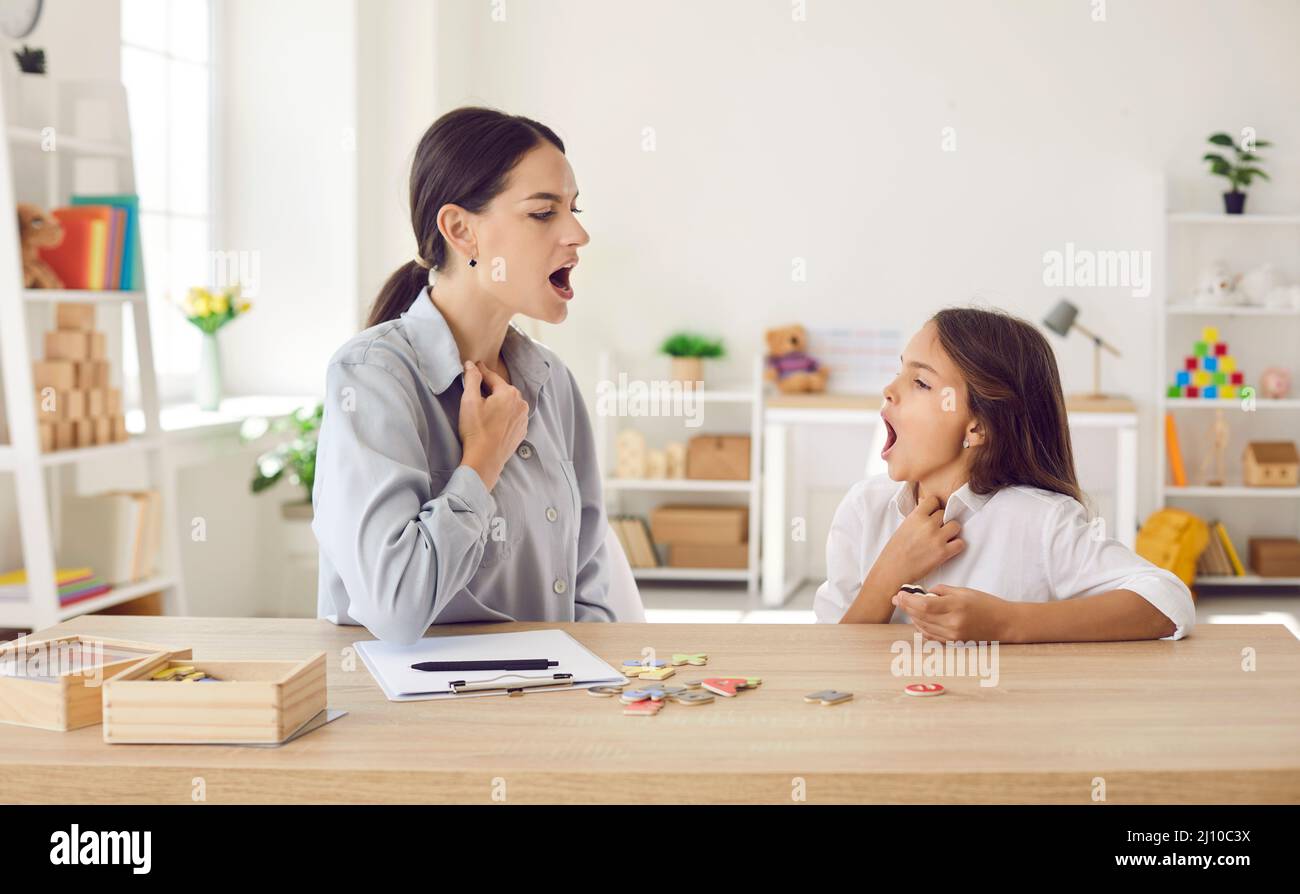 Child who has pronunciation problems learning to articulate sounds with speech therapist Stock Photo