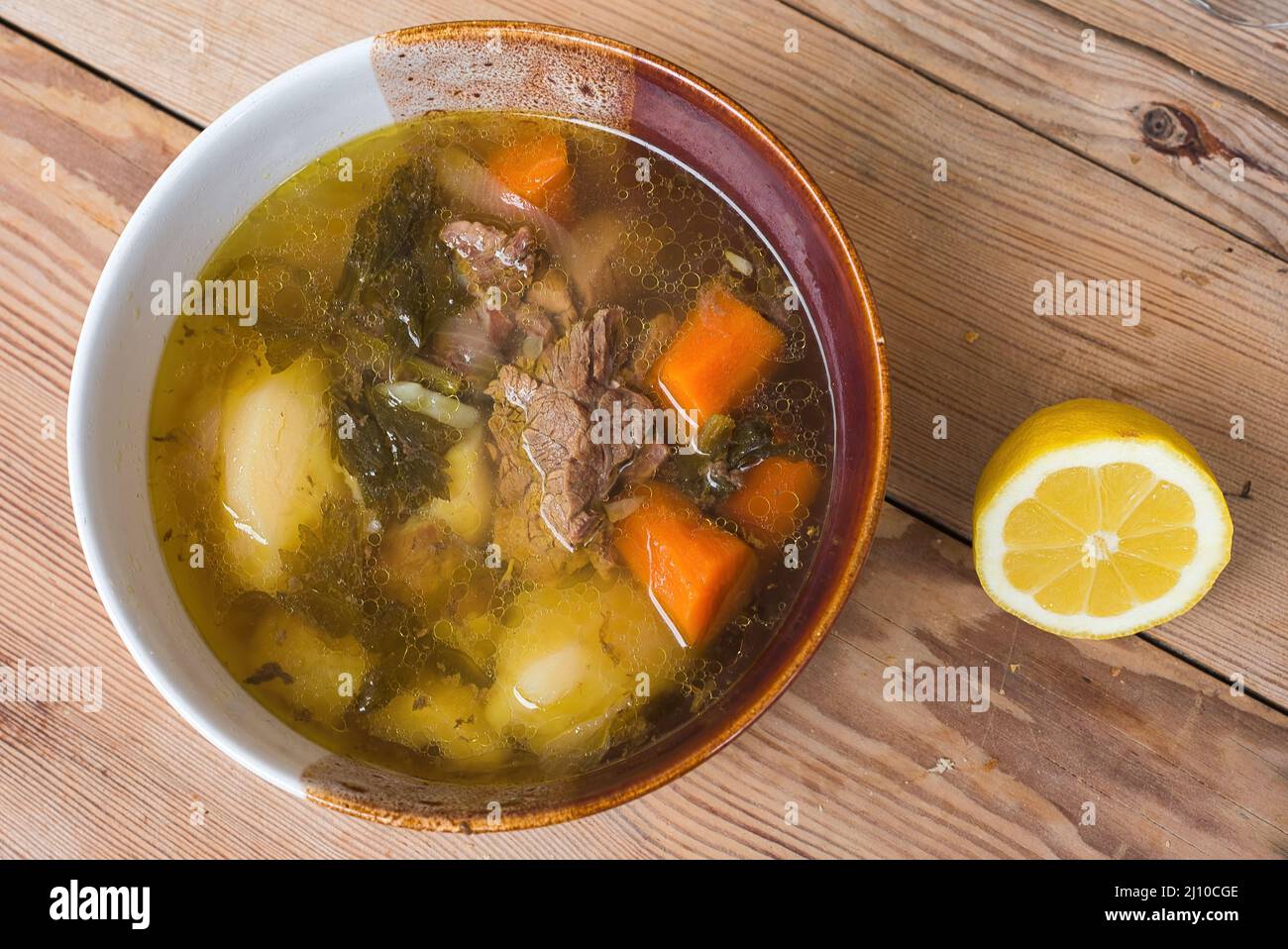 Meat soup, traditional Greek cuisine. Classic soup of the traditional