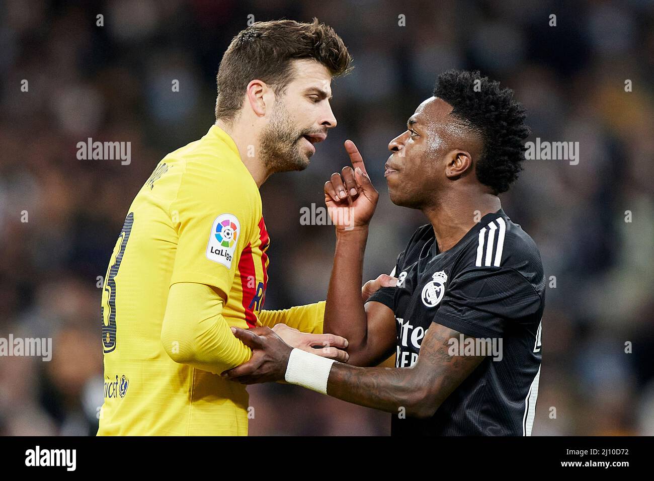 Gerard Pique of FC Barcelona and Vinicius Jr. of Real Madrid during the La Liga match between Real Madrid and FC Barcelona played at Santiago Bernabeu Stadium on March 20, 2022 in Madrid, Spain. (Photo by Ruben Albarran / PRESSINPHOTO) Stock Photo