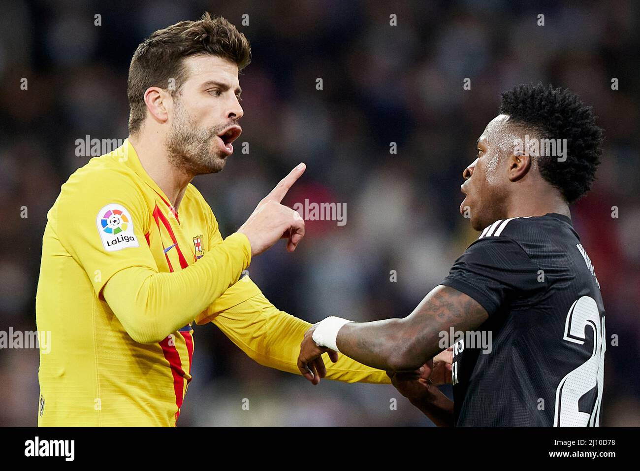 Gerard Pique of FC Barcelona and Vinicius Jr. of Real Madrid during the La Liga match between Real Madrid and FC Barcelona played at Santiago Bernabeu Stadium on March 20, 2022 in Madrid, Spain. (Photo by Ruben Albarran / PRESSINPHOTO) Stock Photo