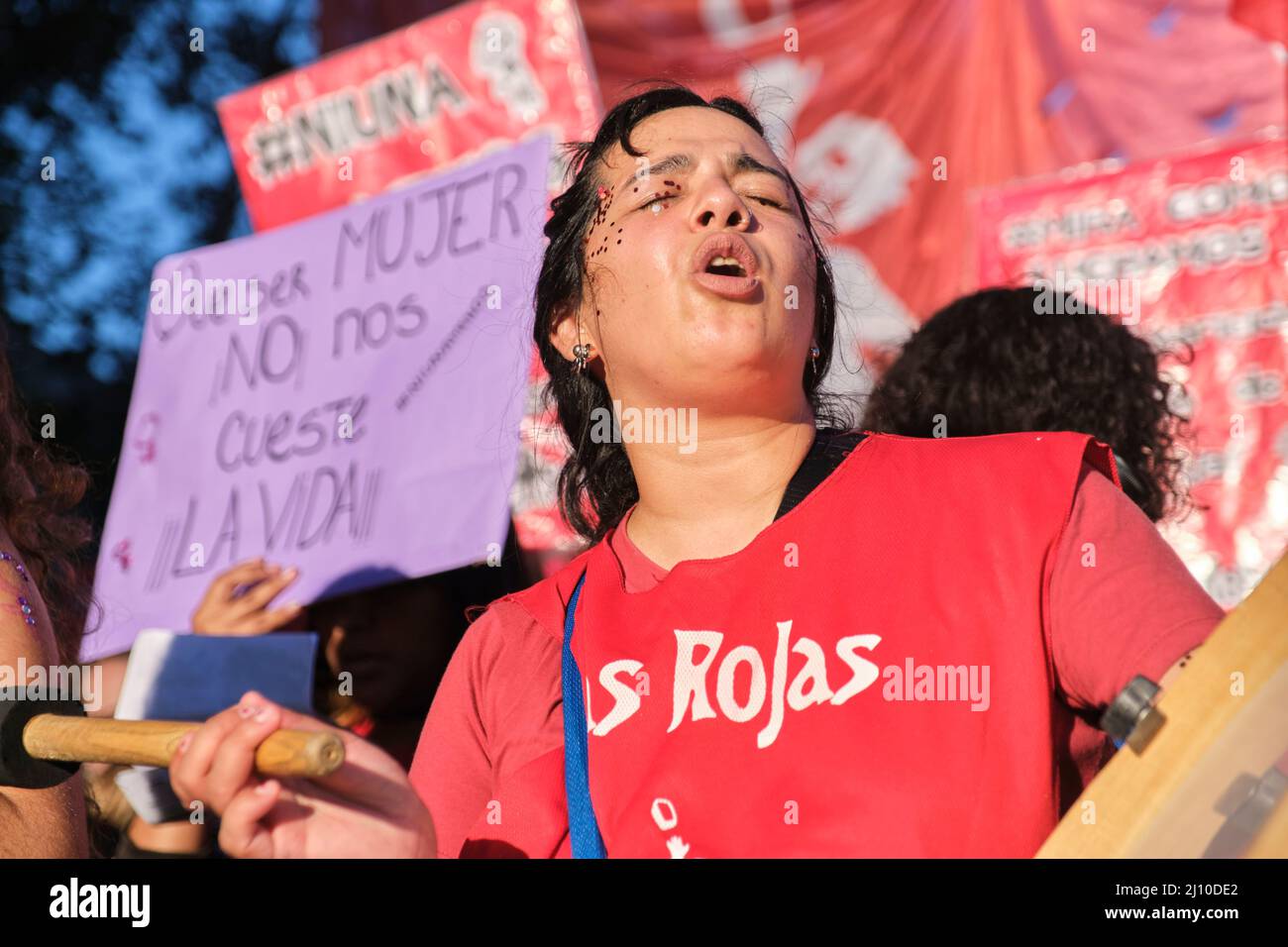 Buenos Aires, Argentina; March 8, 2022: International feminist strike; young woman playing music and chanting slogans, claiming the rights of women Stock Photo